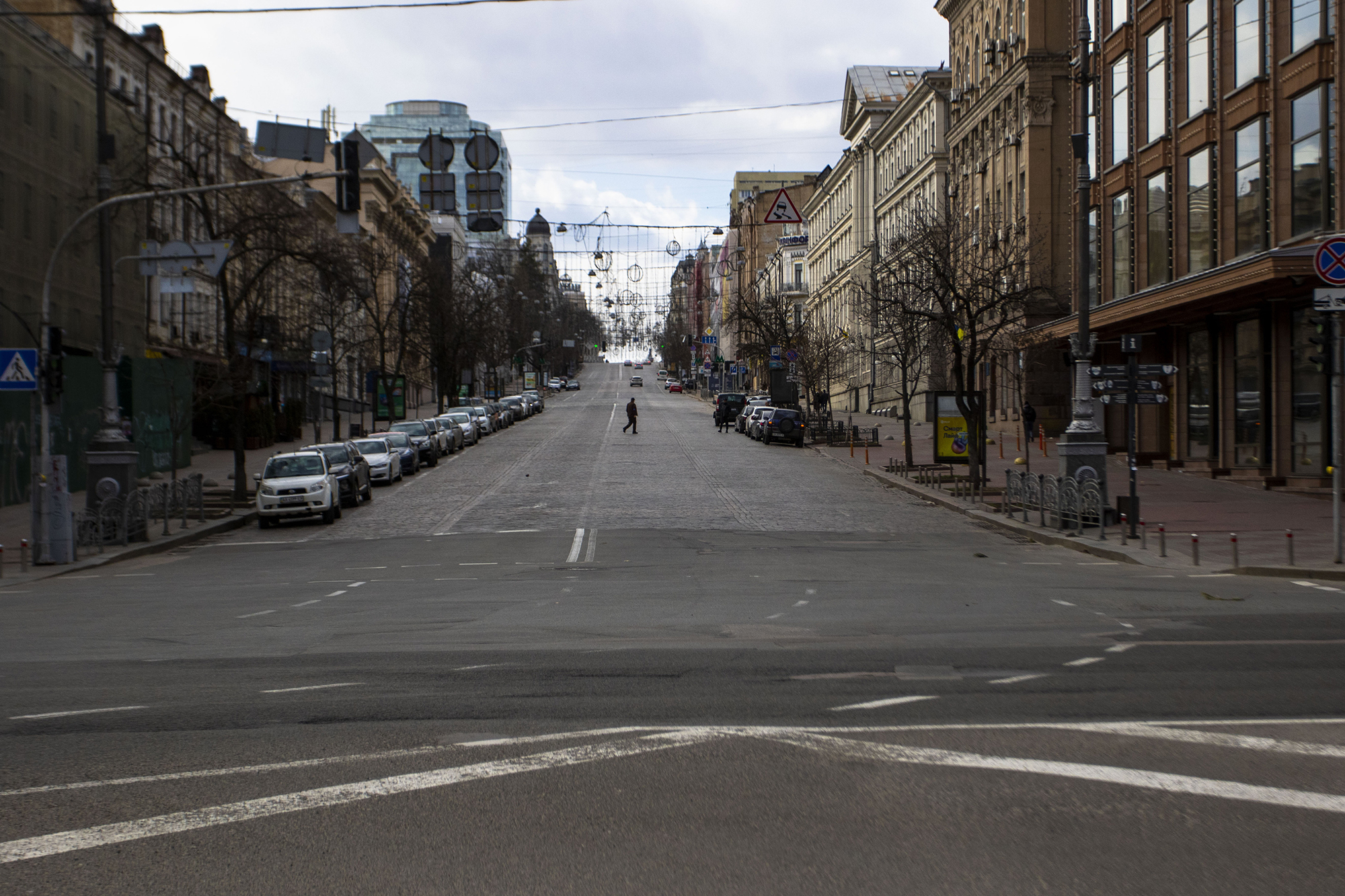 A man walks across what would normally be a busy road during the curfew in Kyiv, Ukraine, on March 27.