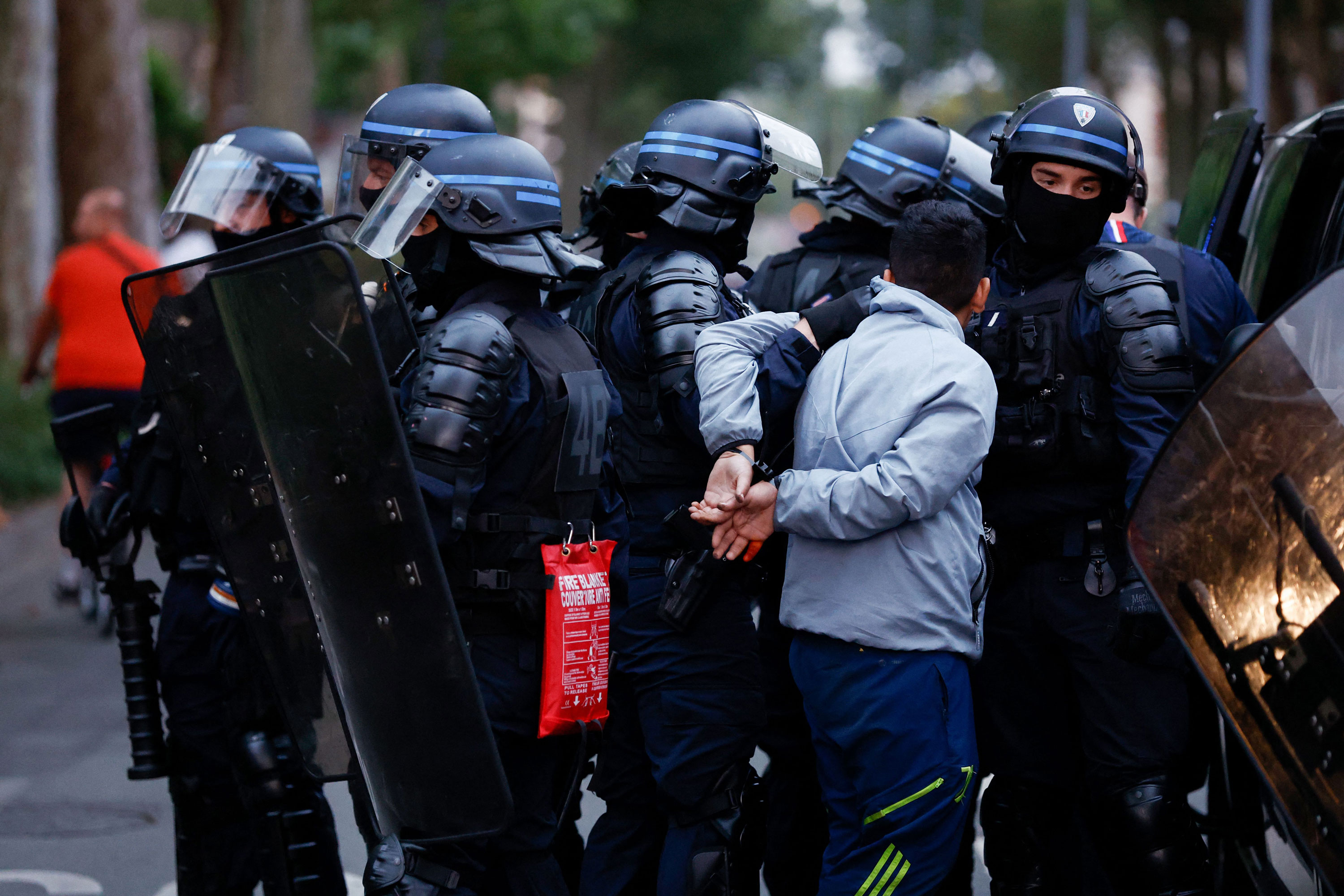 Police officers arrest a man during protests in Lille, northern France, on June 29.