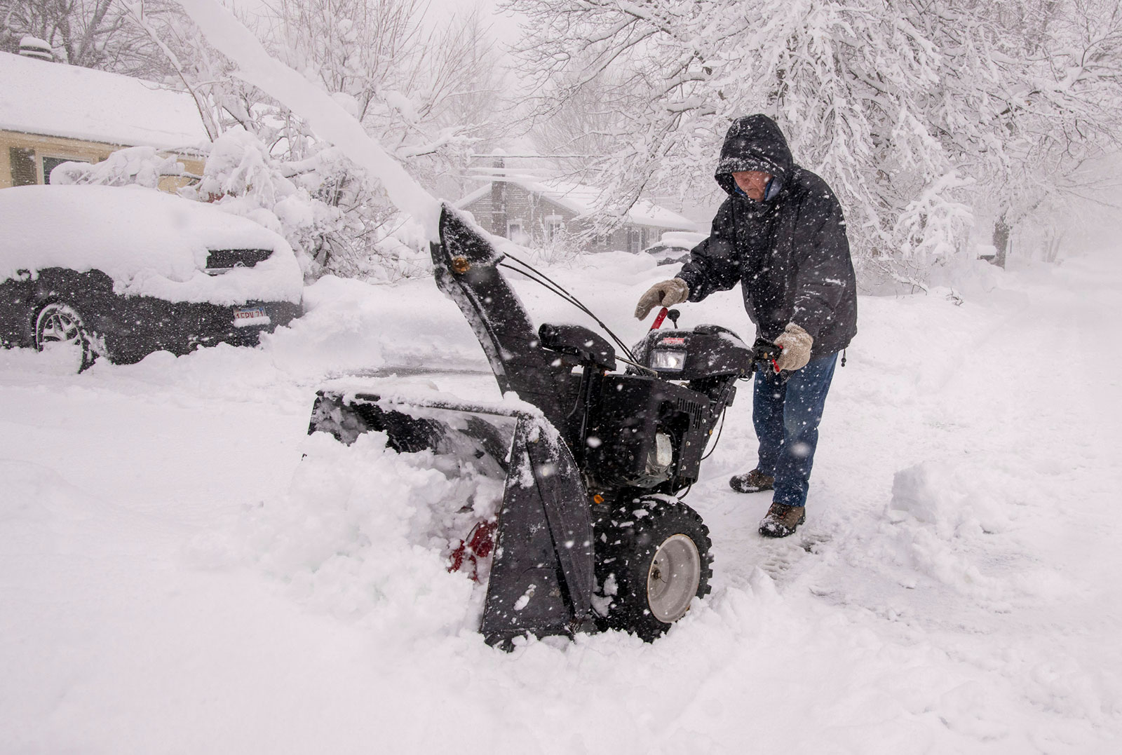 Paul Horgan clears his driveway for the second time this morning as more than a foot of snow has fallen in Northern Worcester County, Massachusetts, on Tuesday, March 14.