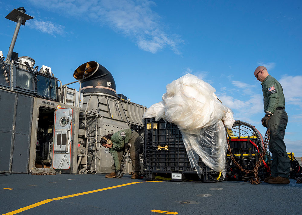 Sailors prepare material recovered in the Atlantic Ocean from a high-altitude balloon for transport to federal agents at Joint Expeditionary Base Little Creek on February 10.