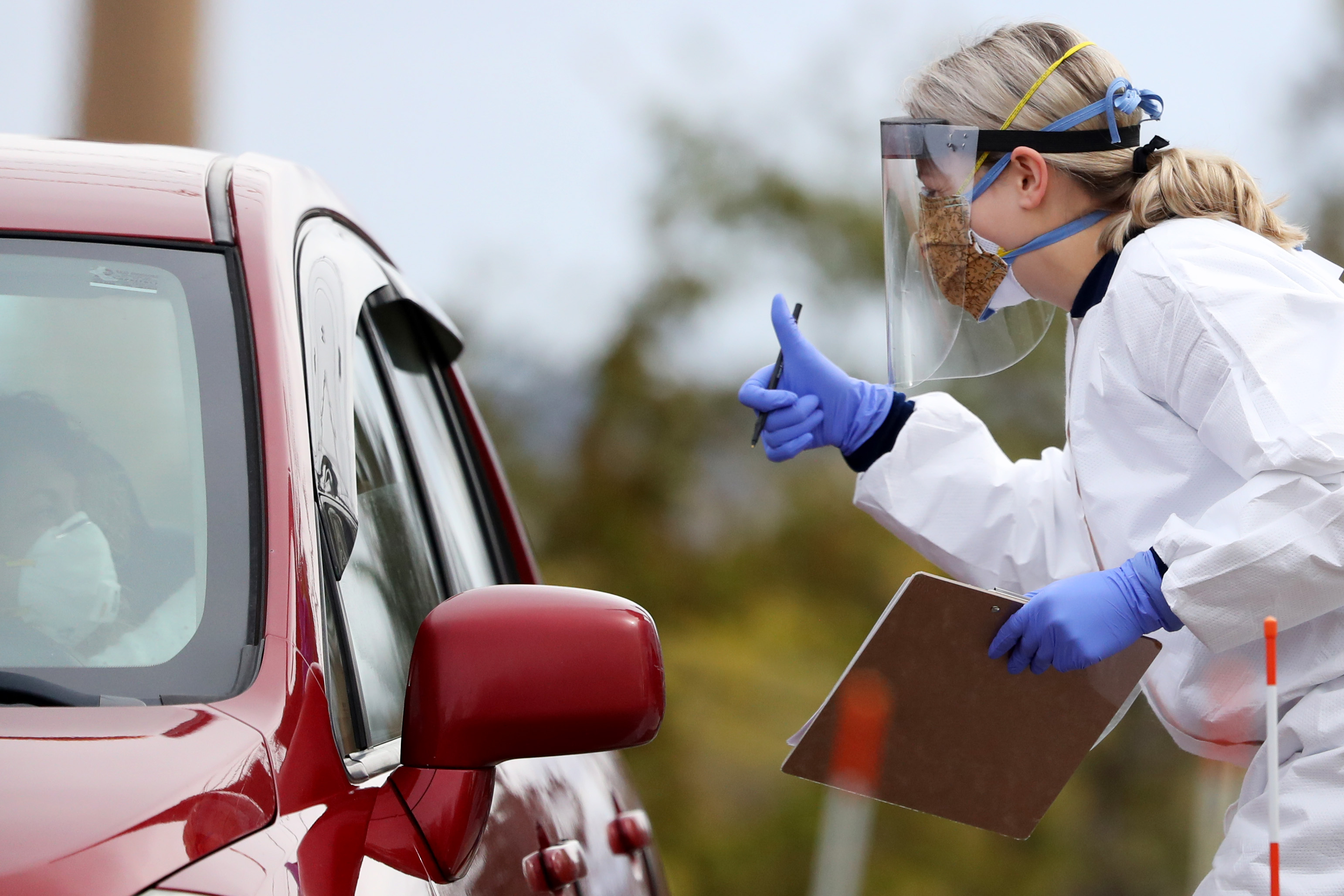 A medical professional works at a drive-thru coronavirus testing site at Cambridge Health Alliance Somerville Hospital in Somerville, Massachusetts, on April 28.