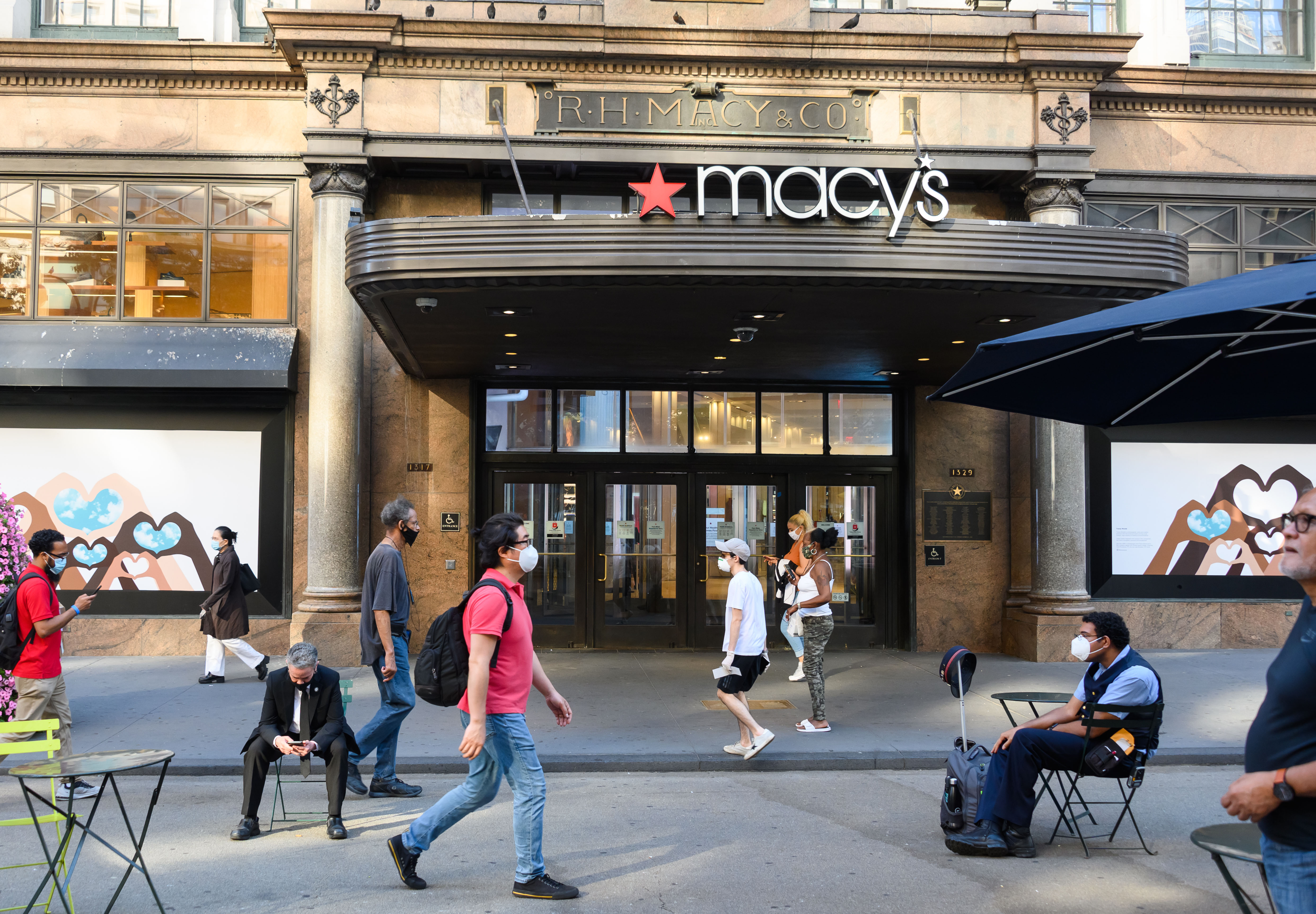 People walk by Macy's Herald Square in New York on June 23.