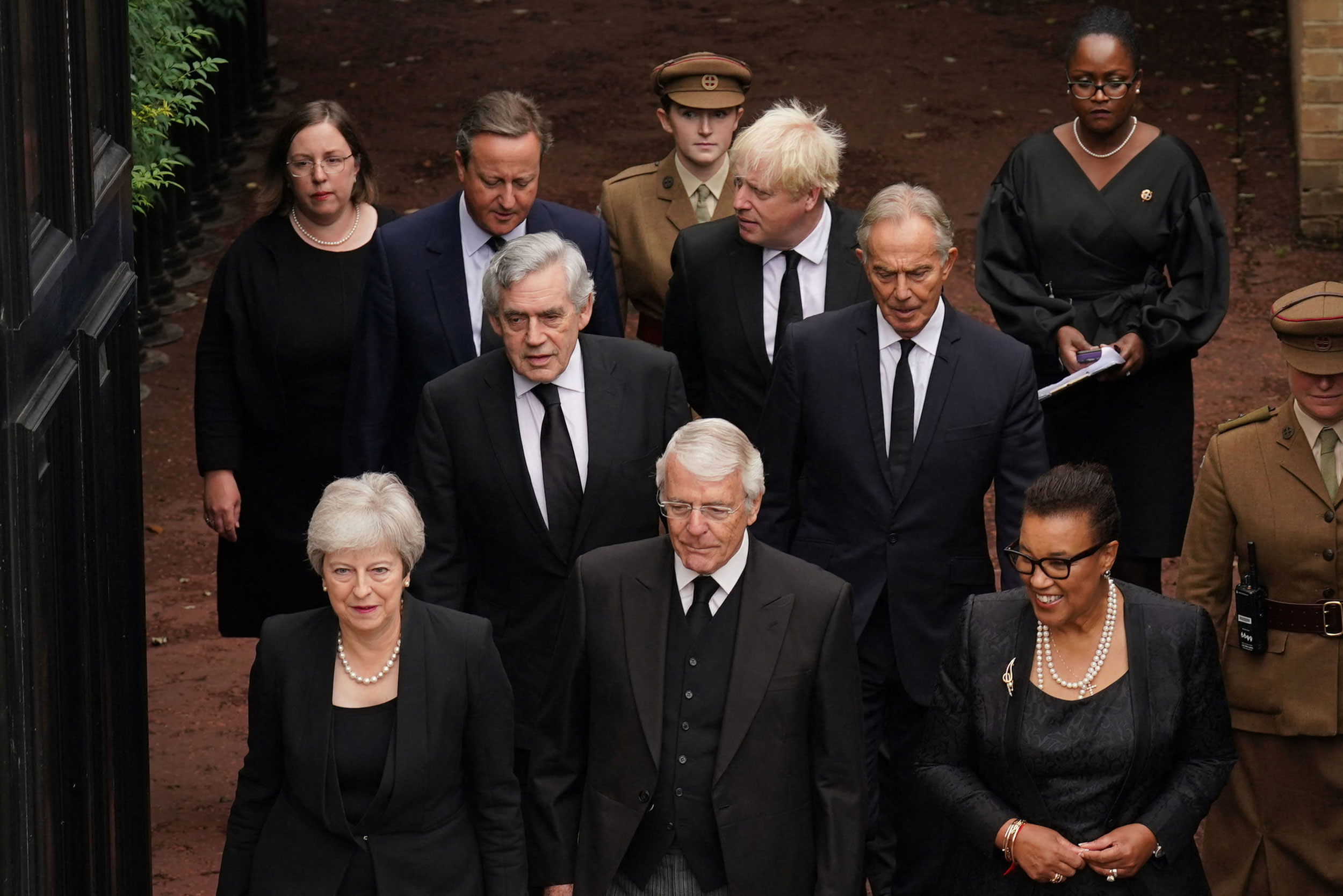 Former British prime ministers attend the ceremony at St. James's Palace on Saturday. In the front row, from left, are Theresa May and John Major, along with Baroness Patricia Scotland. In the second row are Gordon Brown, left, and Tony Blair. Behind them are David Cameron and Boris Johnson.
