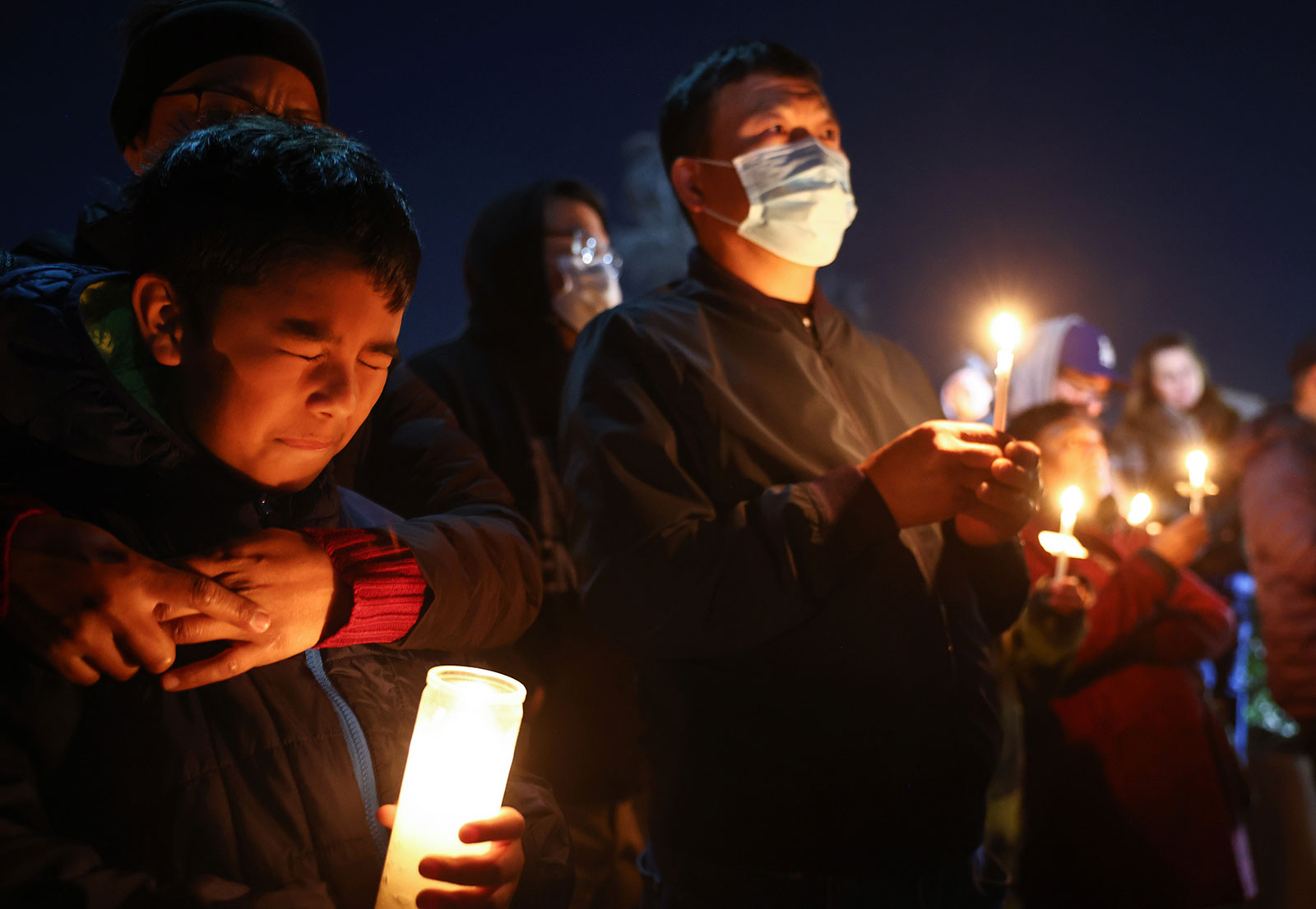 People gather at a candlelight vigil for victims of a deadly mass shooting in Monterey Park, California, on Monday evening, January 23. 