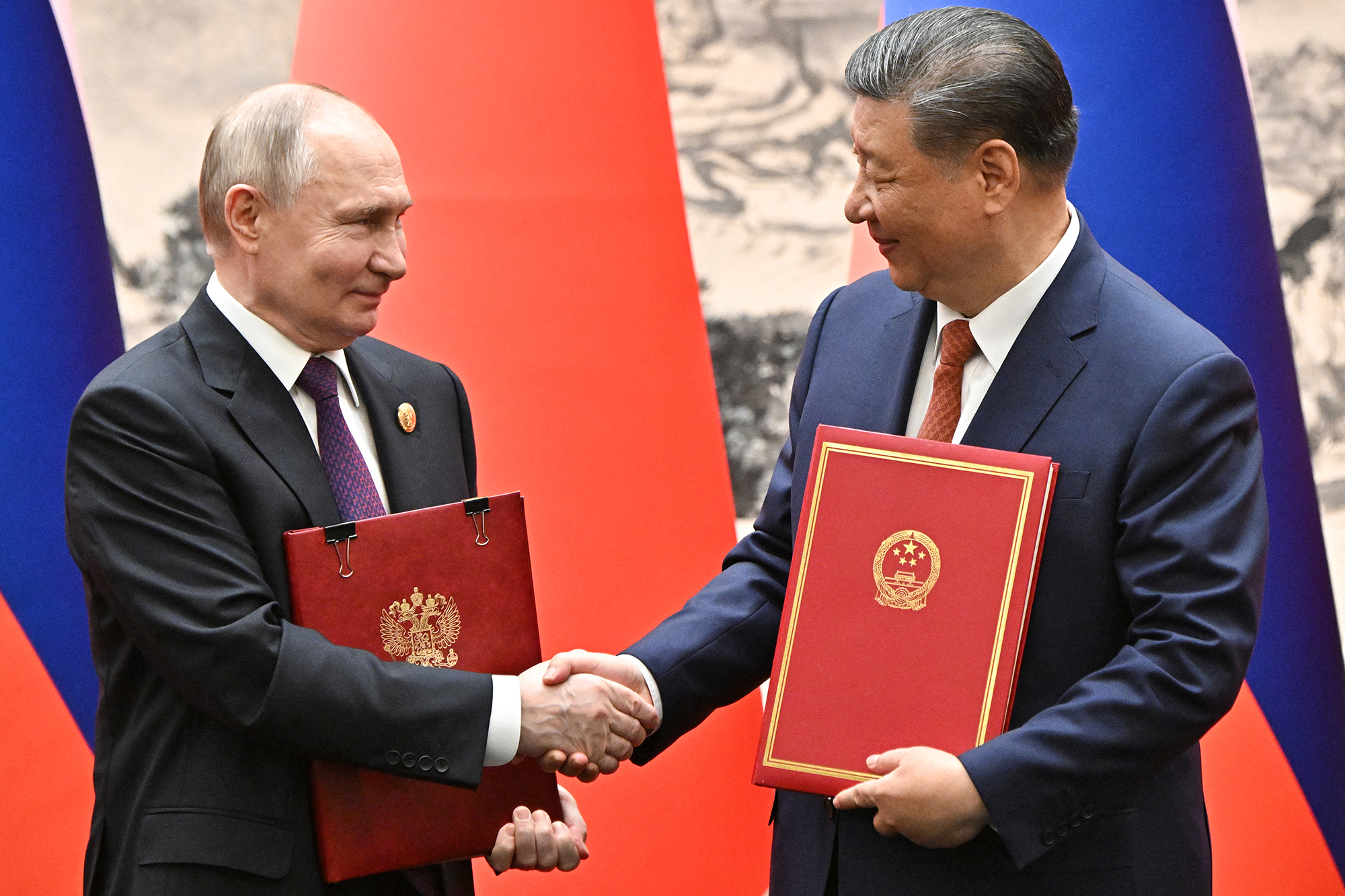 Russia's President Vladimir Putin, left, and China's President Xi Jinping exchange documents during a signing ceremony following their talks in Beijing on May 16.