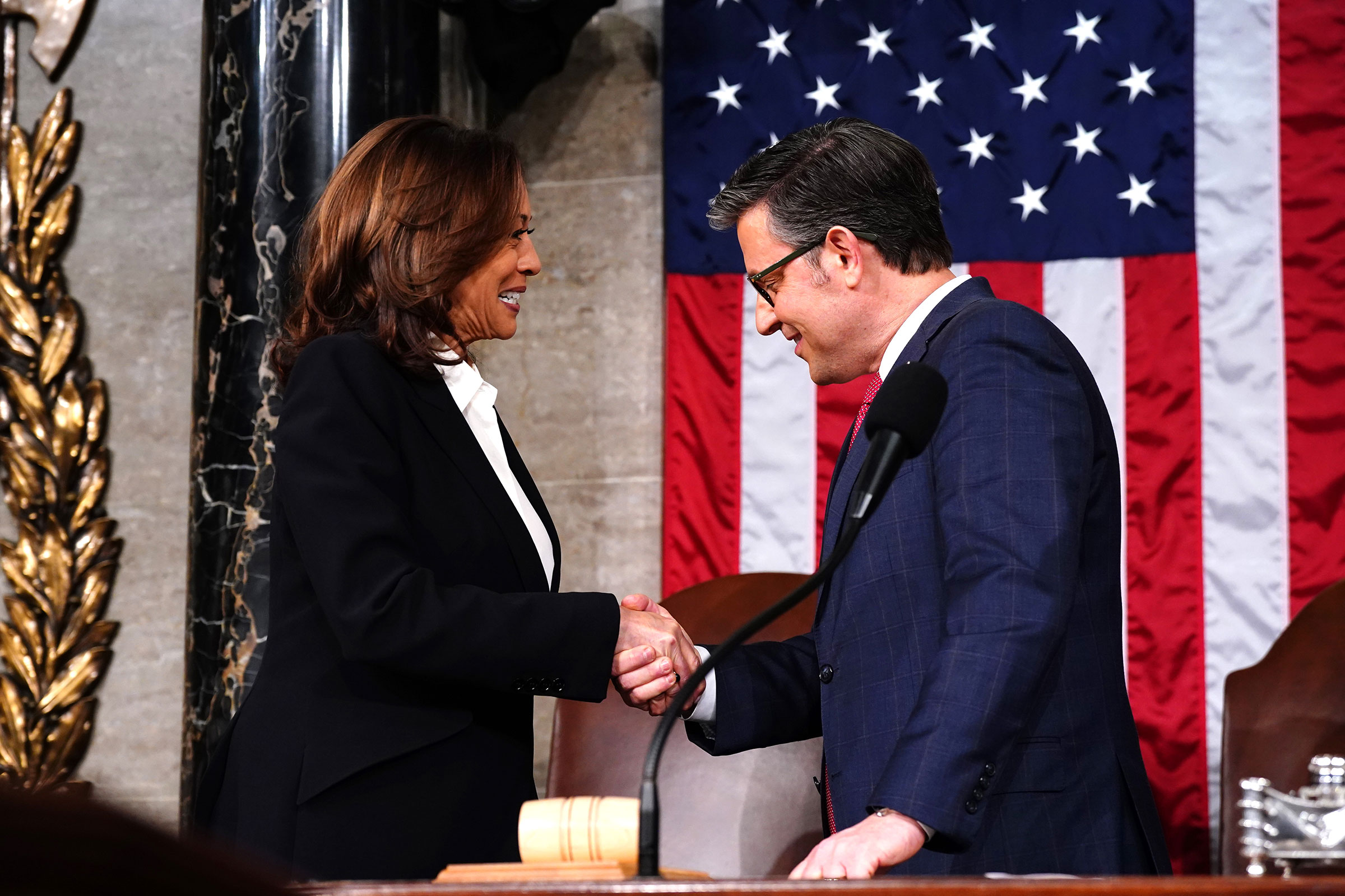 House Speaker Mike Johnson and Vice President Kamala Harris shake hands ahead of the annual State of the Union address by President Joe Biden before a joint session of Congress in the House chamber at the Capital building on March 7 in Washington, DC. 