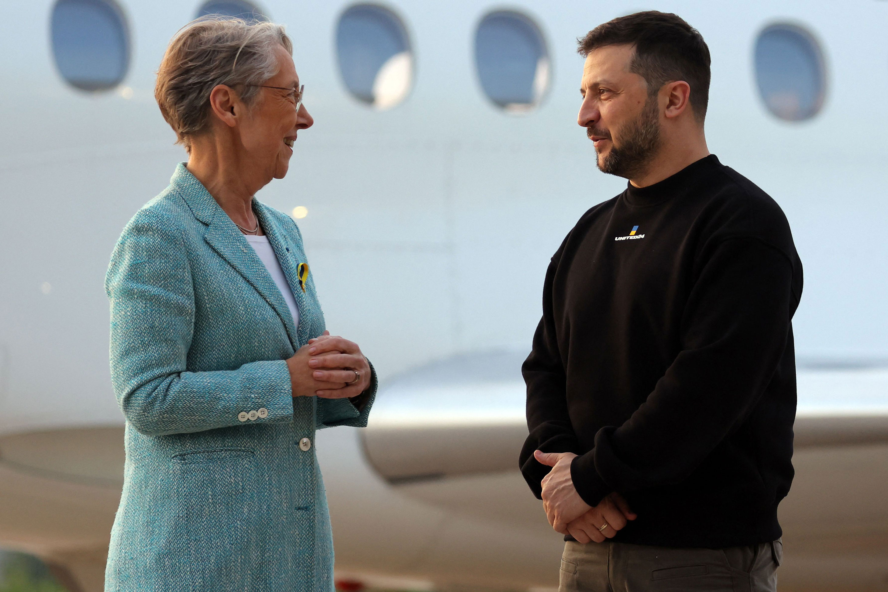 French Prime minister Elisabeth Borne, left, welcomes Ukrainian President Volodymyr Zelensky upon his arrival at Villacoublay Air Base, southwest of Paris, on May 14. 