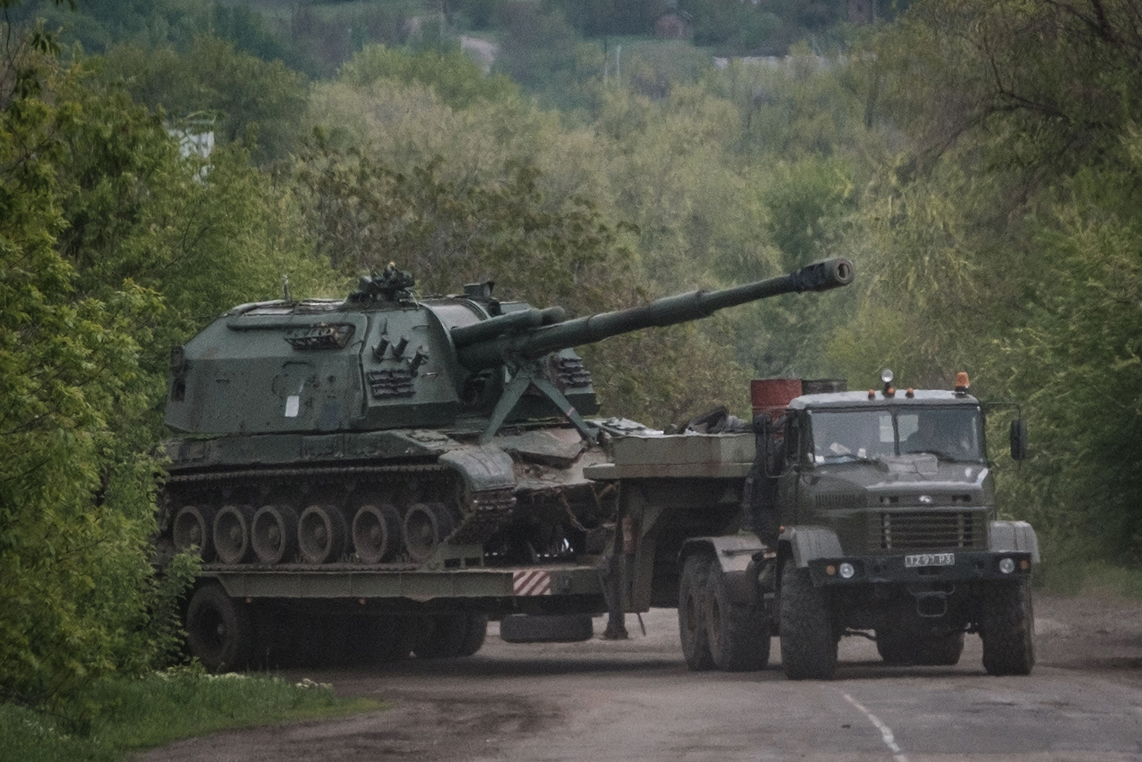 This photograph taken on May 10, 2022, shows an Ukrainian Army's self-propelled howitzer loading on a tank transporter near Bakhmut, eastern Ukraine, amid the Russian invasion of Ukraine.