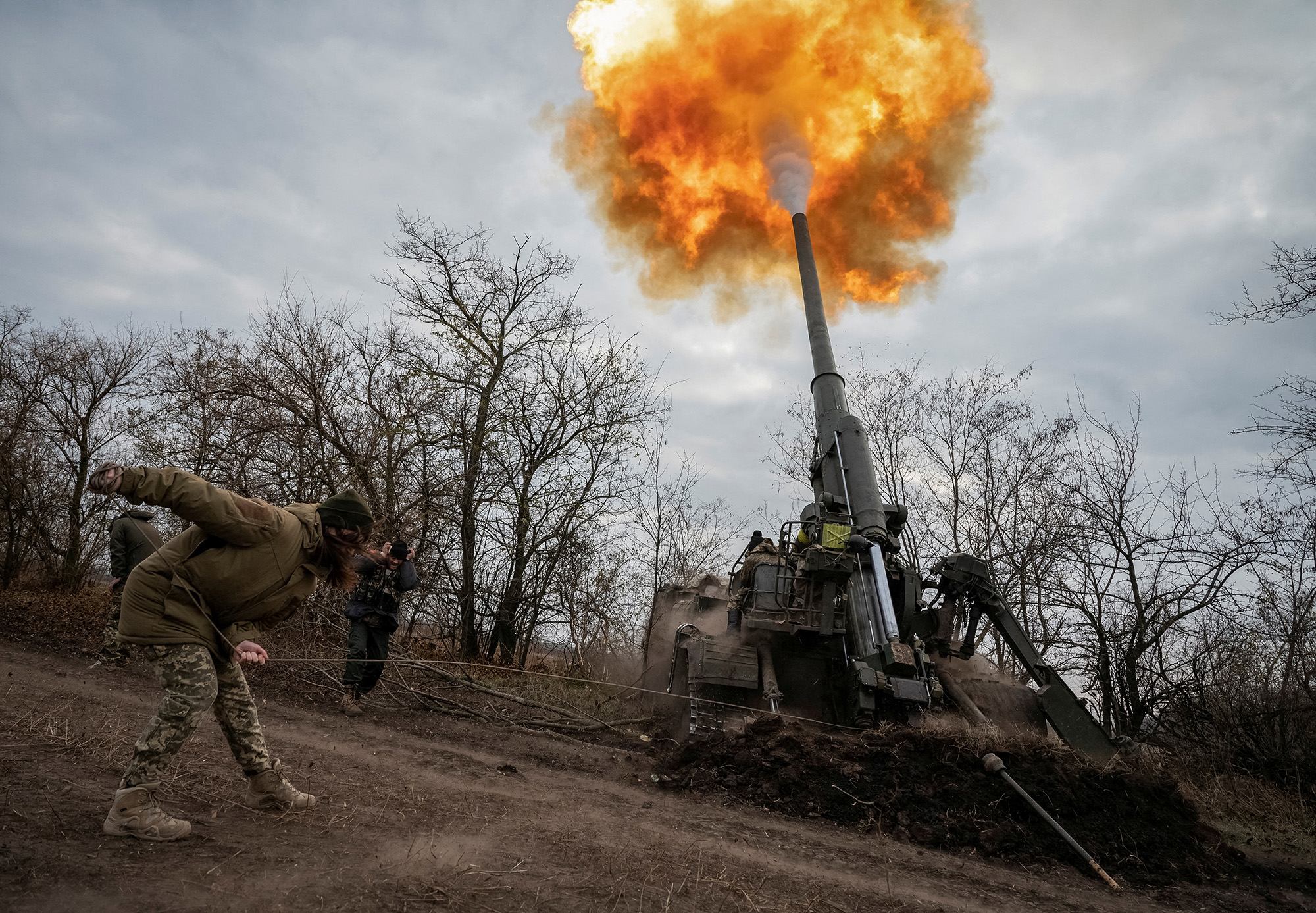 A Ukrainian servicewoman fires a 2S7 Pion self-propelled gun at a position on the frontline in Kherson region, Ukraine, on November 9.