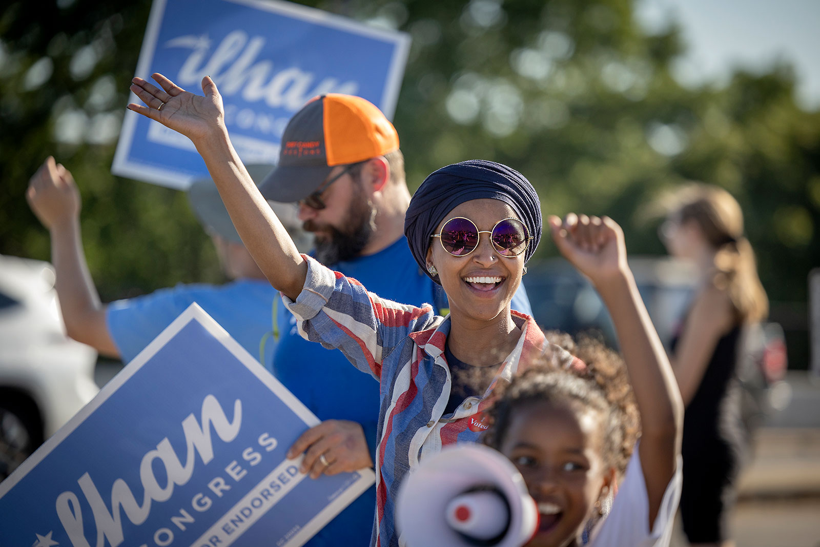 Rep. Ilhan Omar waves during a voter engagement event on the corner of Broadway and Central Avenues in Minneapolis, Minnesota on Tuesday, August 9. 