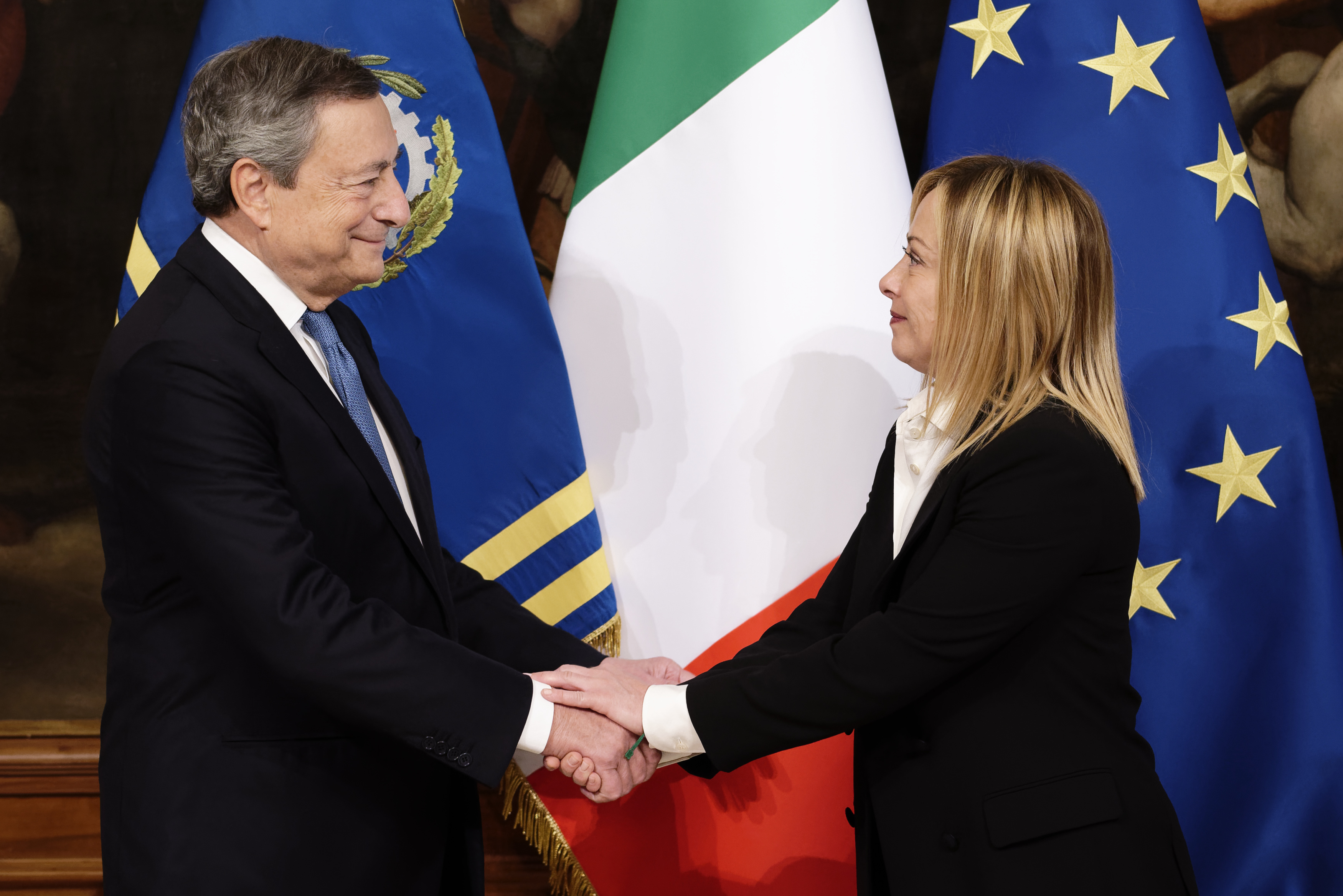 Mario Draghi and Italy's new prime minister, Giorgia Meloni shake hands during the cabinet minister bell handover ceremony at Palazzo Chigi in Rome, on Sunday.