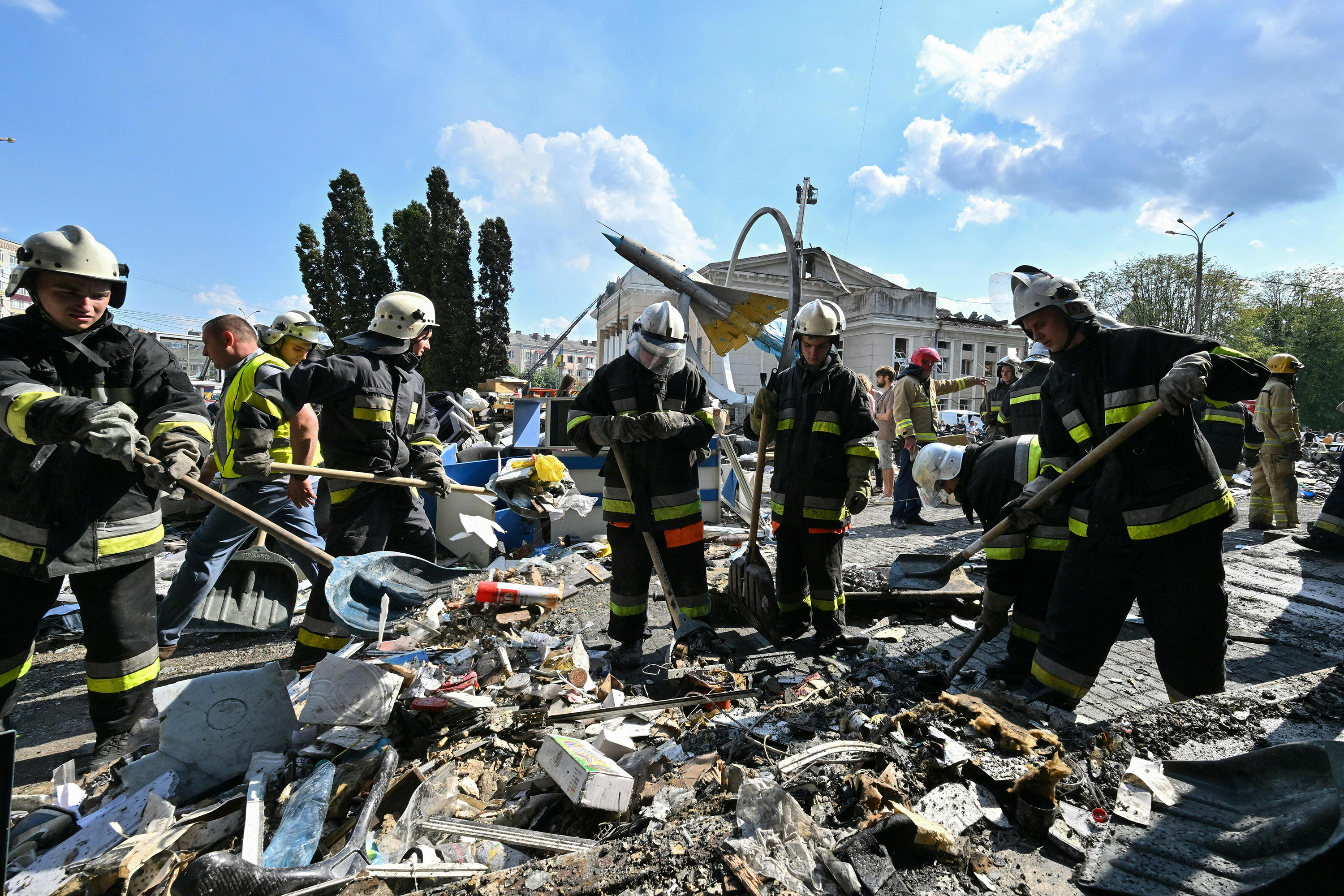 Firefighters dig through the rubble of a damaged building in Vinnytsia on July 14. 