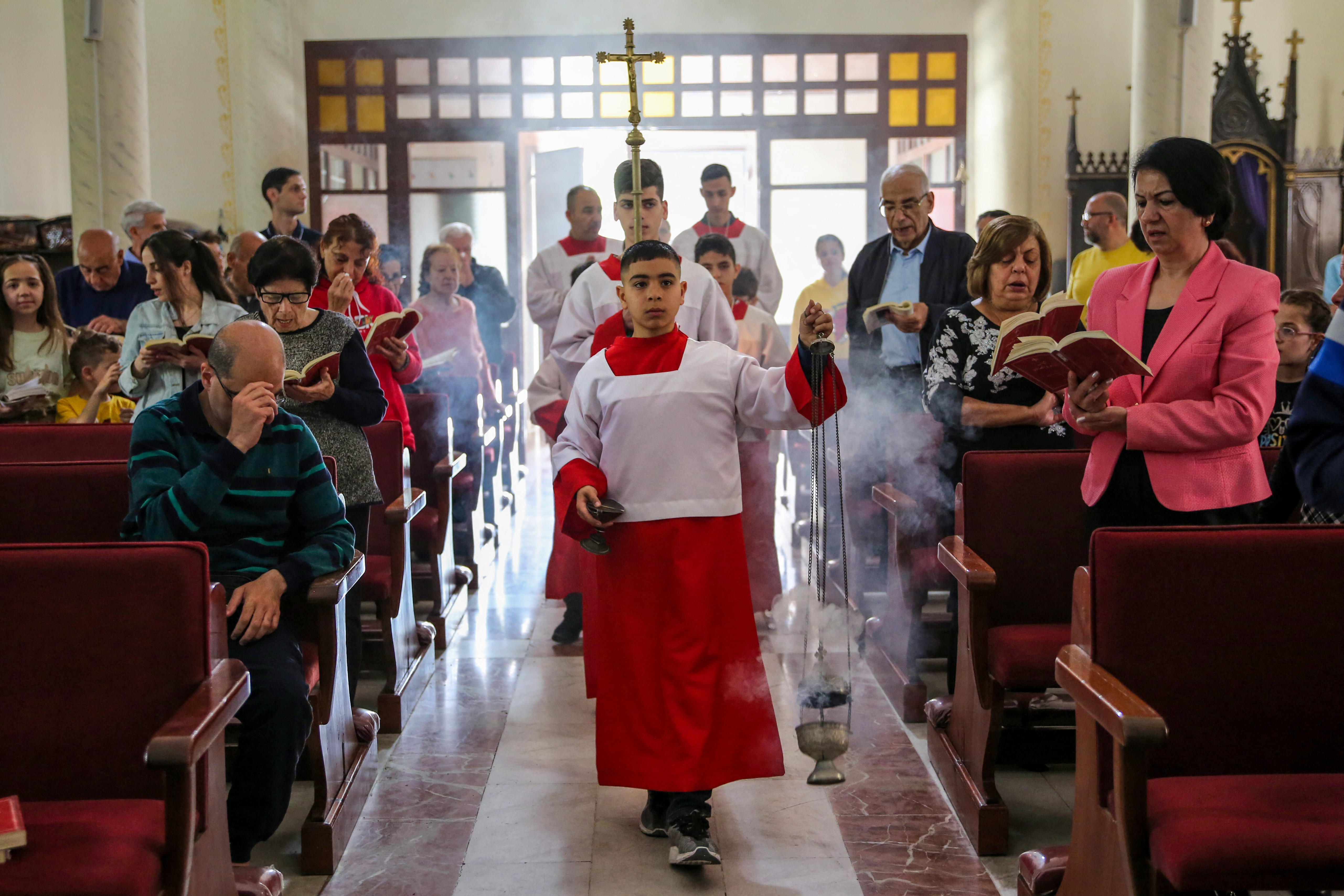 People attend Easter Sunday Mass at the Holy Family Church in Gaza City on March 31.