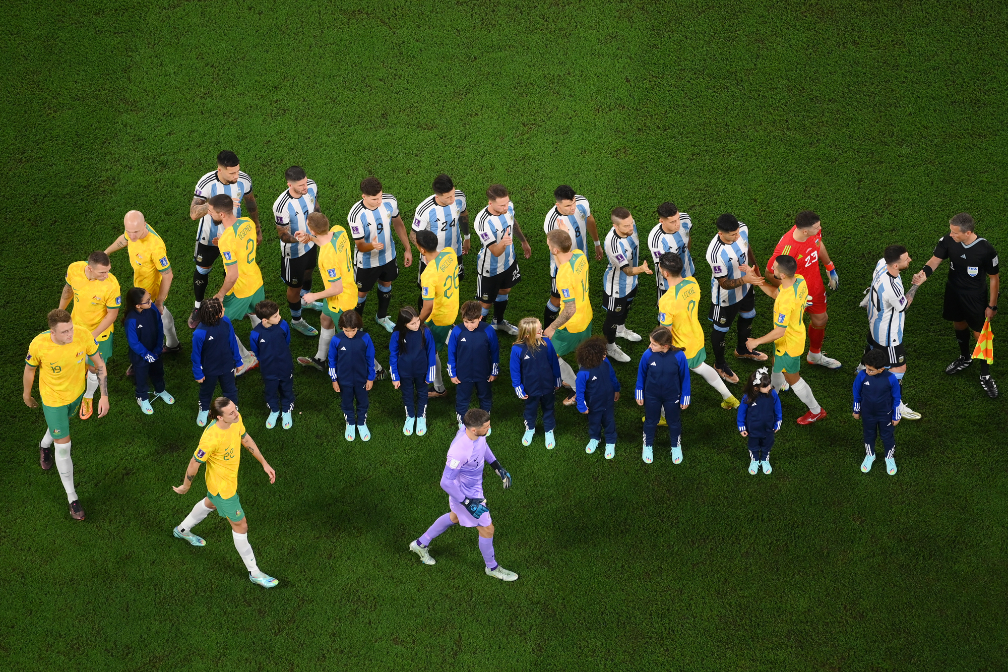 Players shake hands before the match between Argentina and Australia at the Ahmed Ben Ali Stadium in Rennes, Qatar, on Saturday.