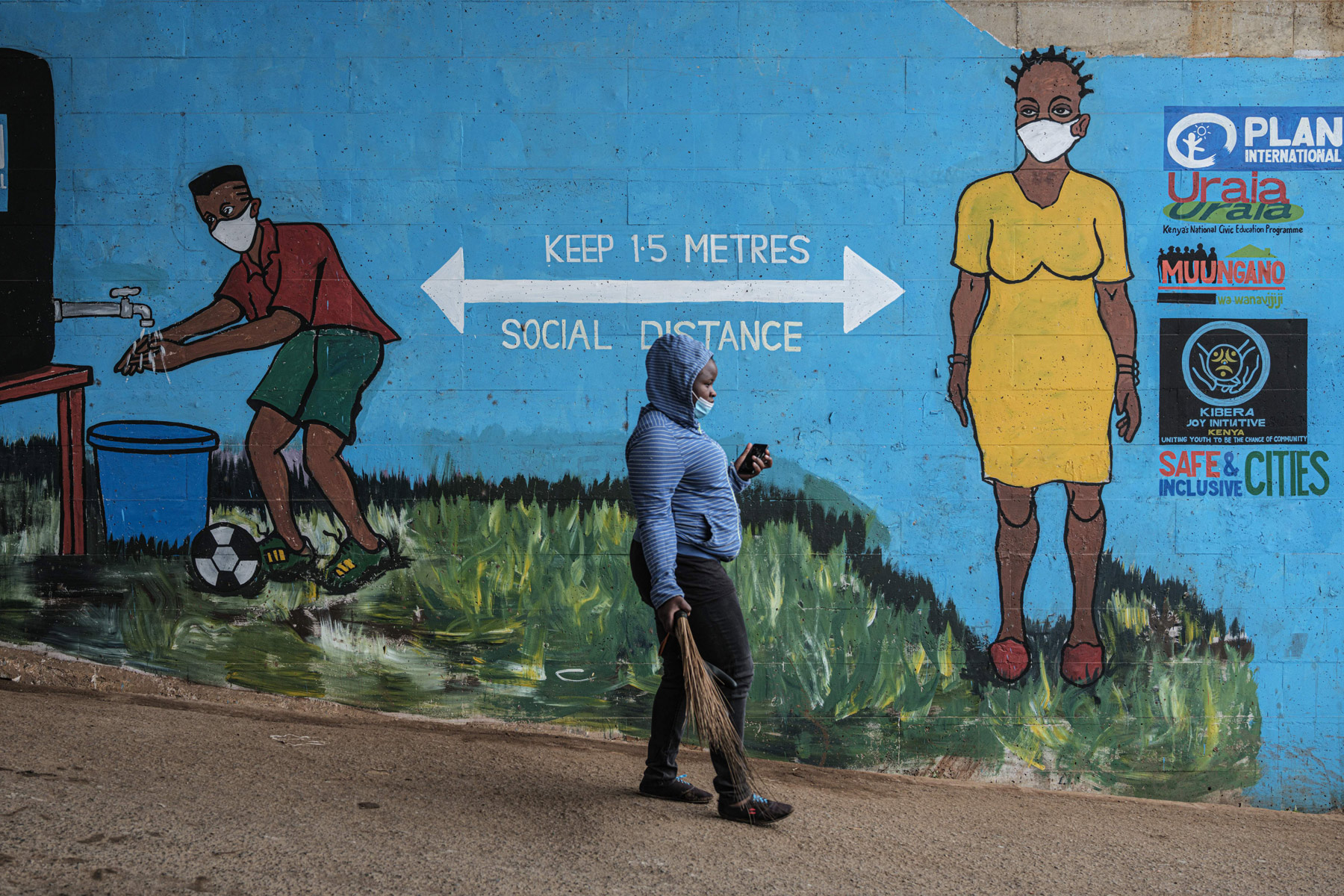 A woman walks in Kibera, Nairobi, Kenya, on July 15.