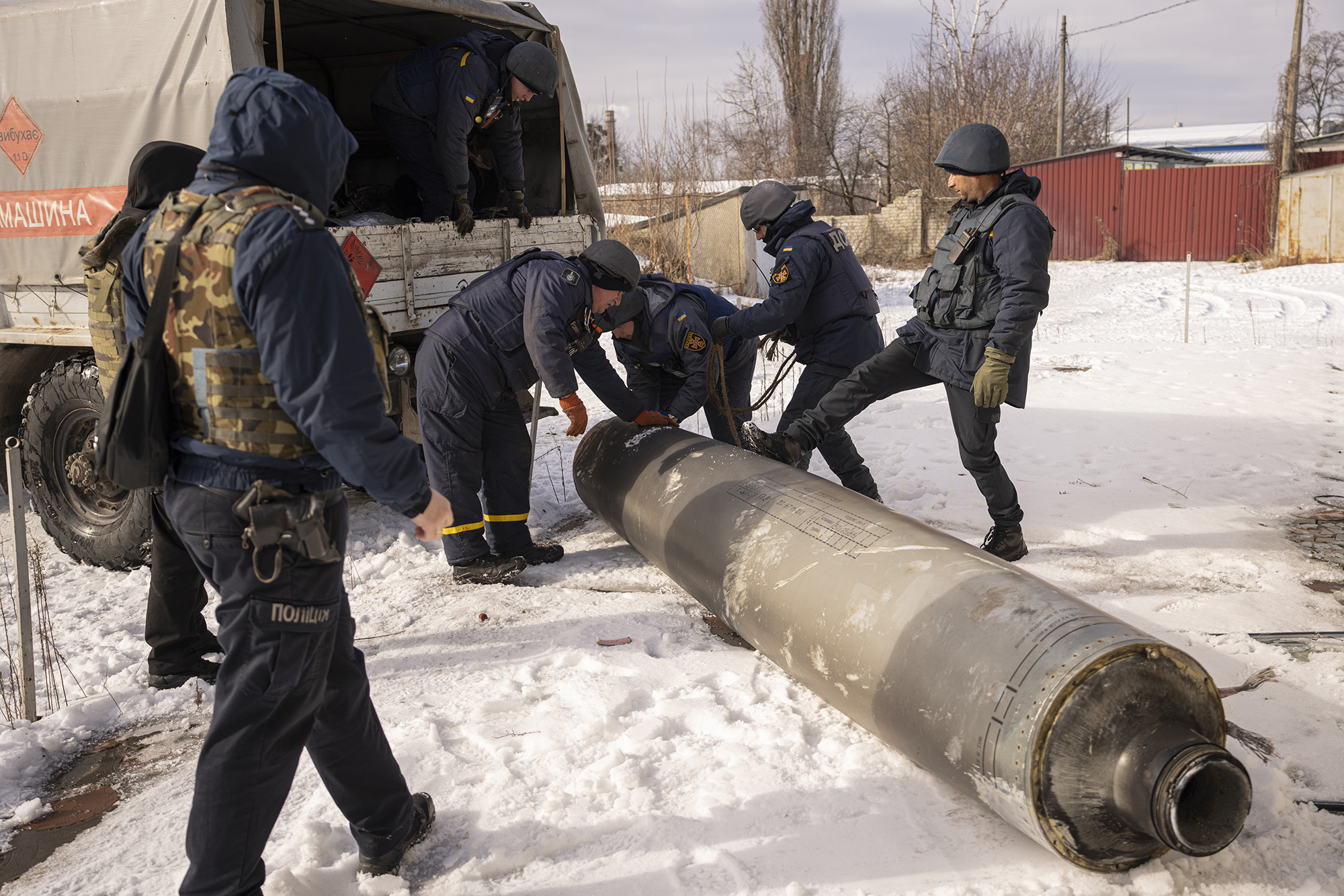 Ukrainian emergency services employees prepare to load the remains of an S-300 missile fired by Russian forces onto a truck in Kharkiv, Ukraine, on February 17.