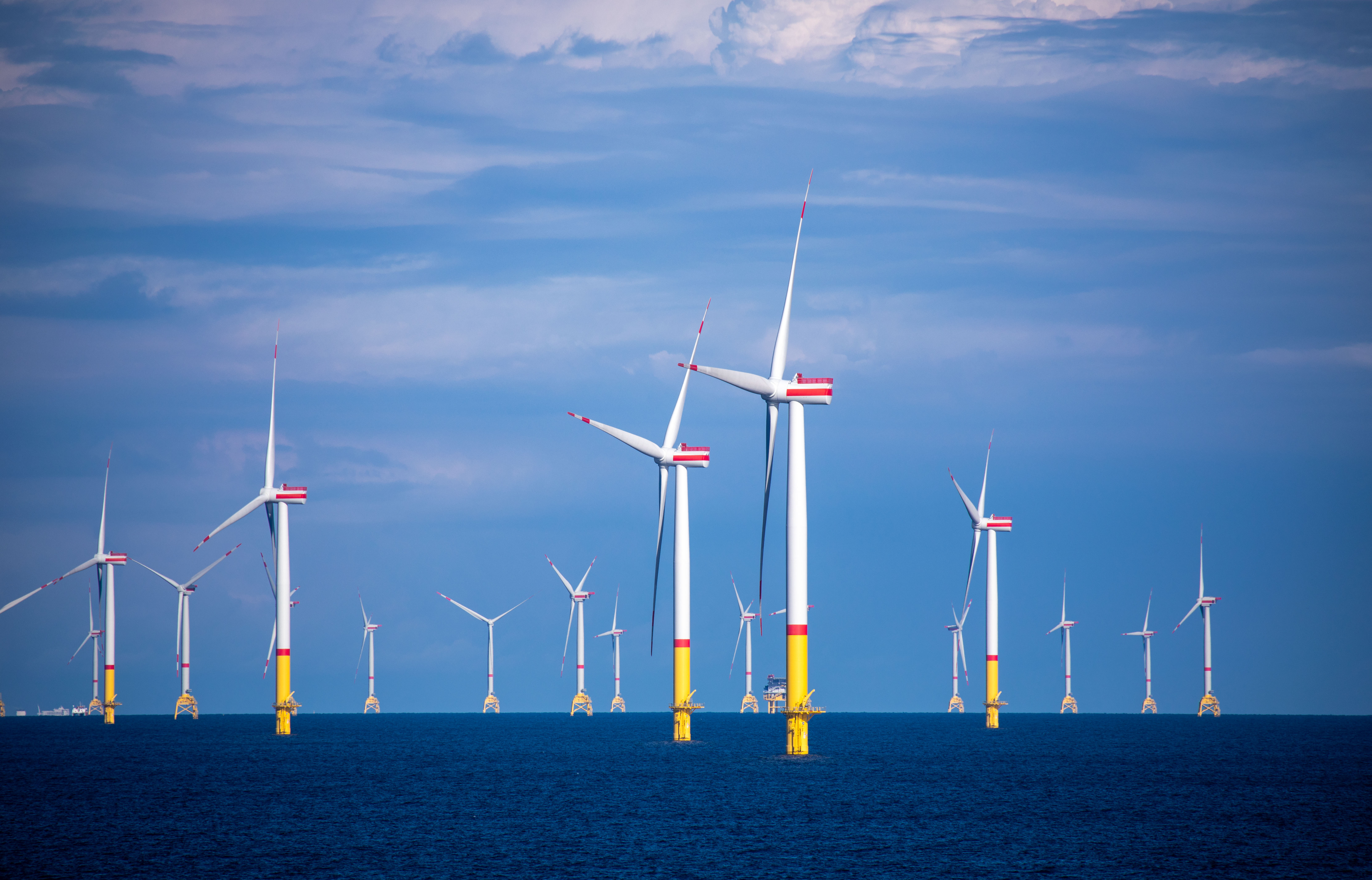 Wind turbines rotate in the Baltic Sea between the islands of Rügen and Bornholm, belonging to Denmark on August 29, 2020. 