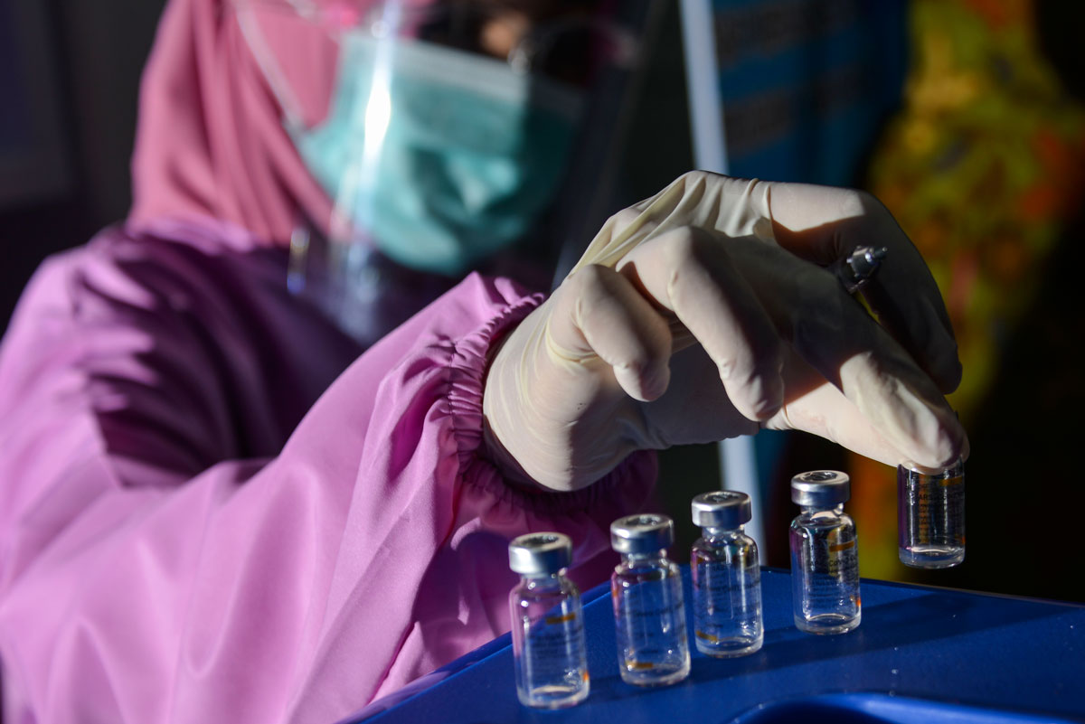 A health worker displays empty vials of the Sinovac vaccine at Meuraxa Hospital in Banda Aceh, Indonesia on January 15.