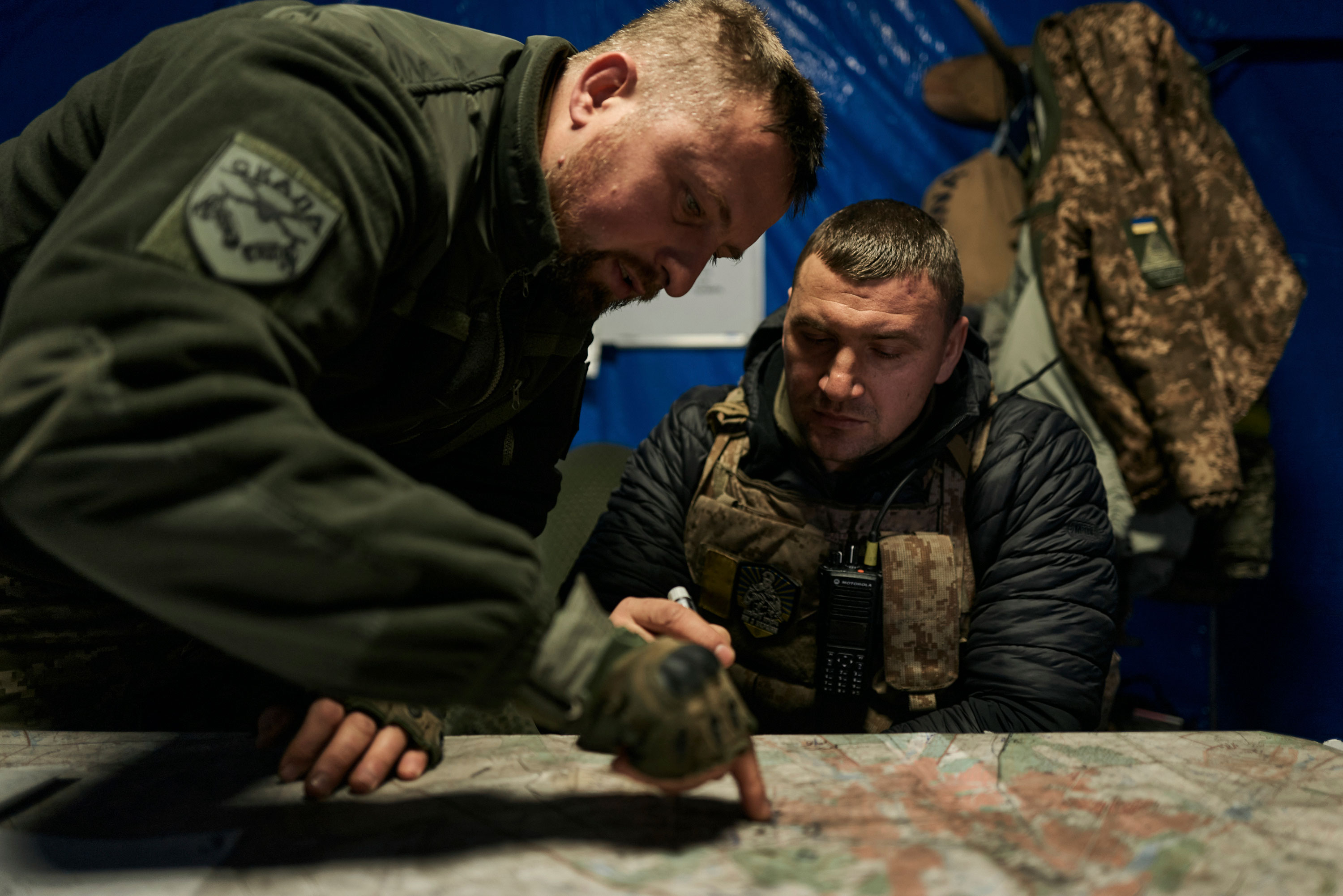 Ukrainian soldiers look at a map in an underground command center in Bakhmut, Ukraine, on Sunday.