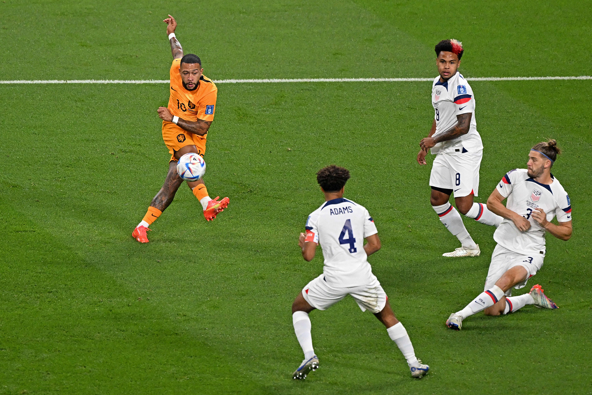 Netherlands' Memphis Depay scores his team's first goal against USA on Saturday, December 3.