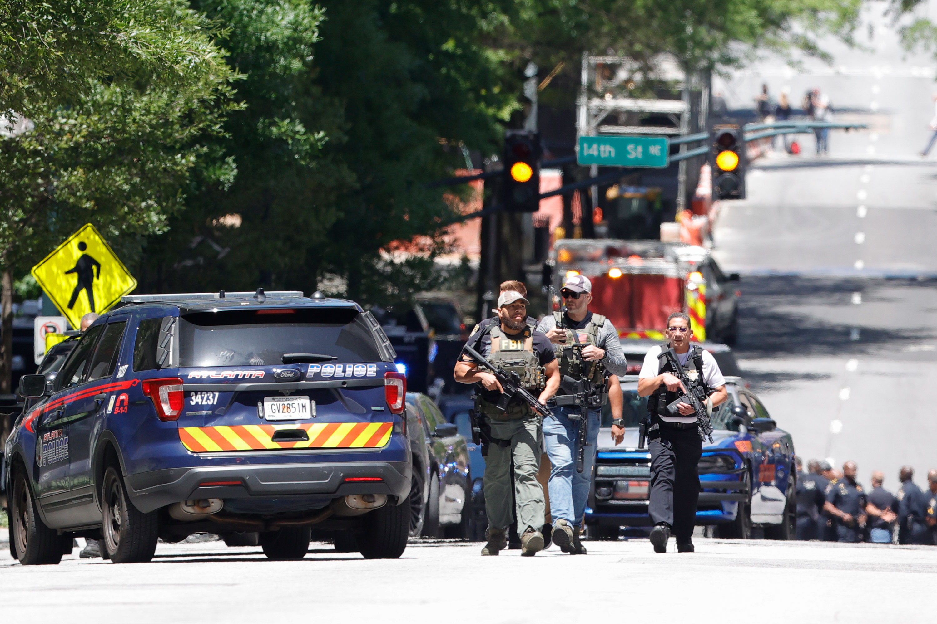 Law enforcement officers arrive near the scene of an active shooter in Midtown Atlanta on Wednesday. 