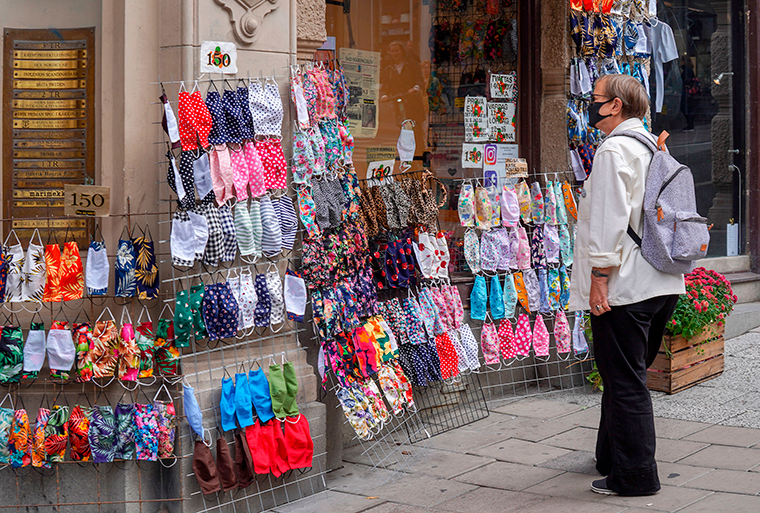 A woman stops to look at fabric face masks on sale in a shop in Stockholm, Sweden, on Monday, August 31. 