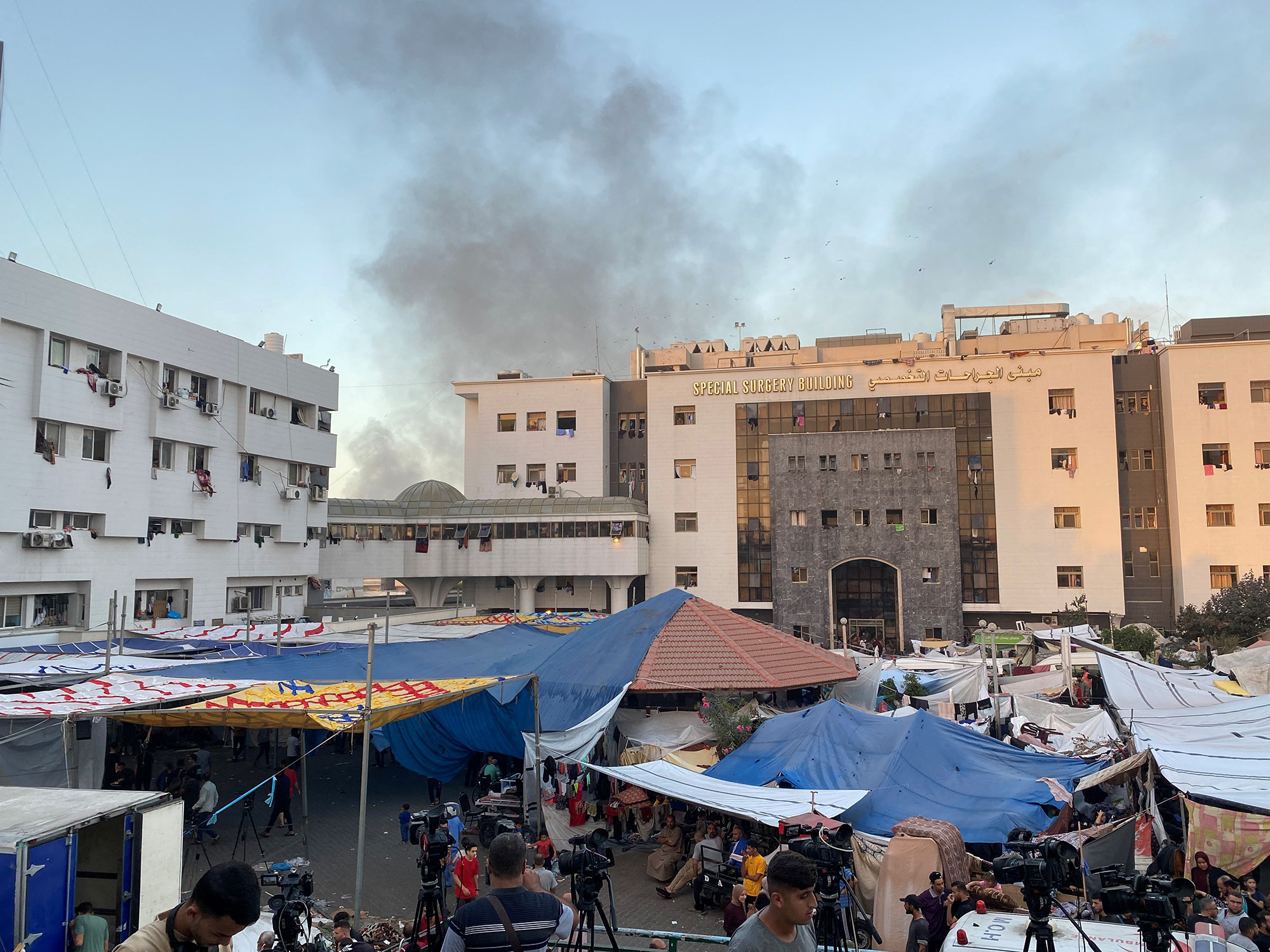 Smoke rises as displaced Palestinians take shelter at Al-Shifa hospital in Gaza City on November 8.