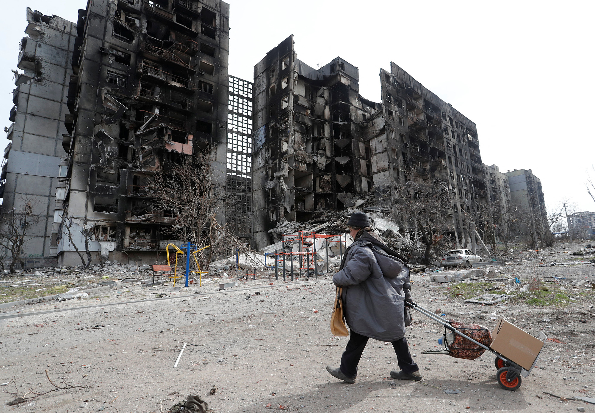 A local resident walks near an apartment building in the southern port city of Mariupol, Ukraine, on April 3.