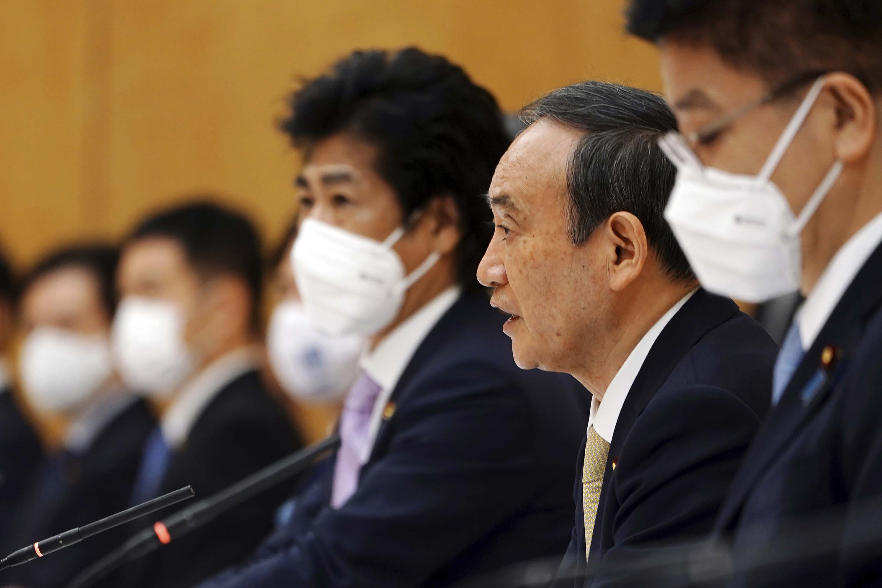 Japanese Prime Minister Yoshihide Suga, second from right, declares a state of emergency for Tokyo and three other prefectures during the government task force meeting on COVID-19 measures in Tokyo, Japan, on Friday, April 23.