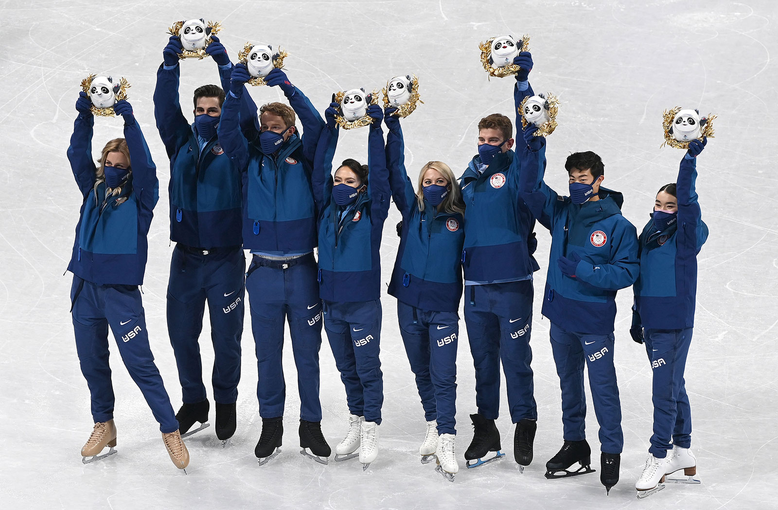 Team USA figure skaters pose for photos during the flower ceremony for the team event on February 7.