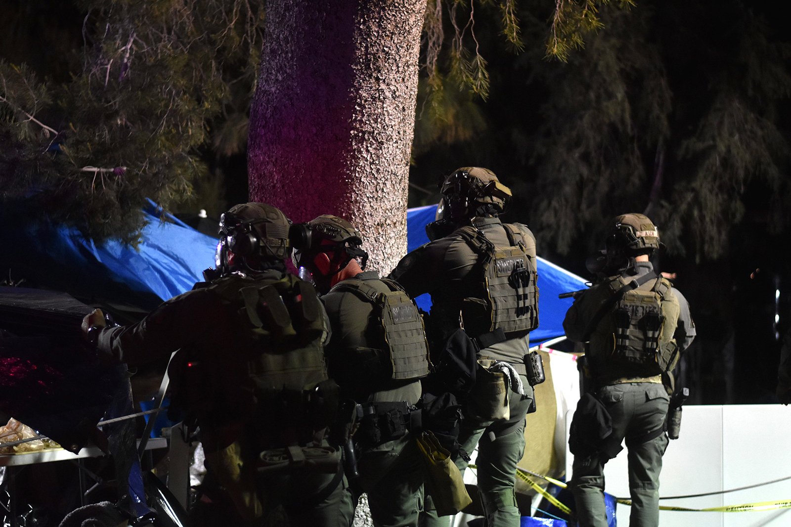 Law enforcement tear down an encampment that protesters had built on the University of Arizona campus on May 1.