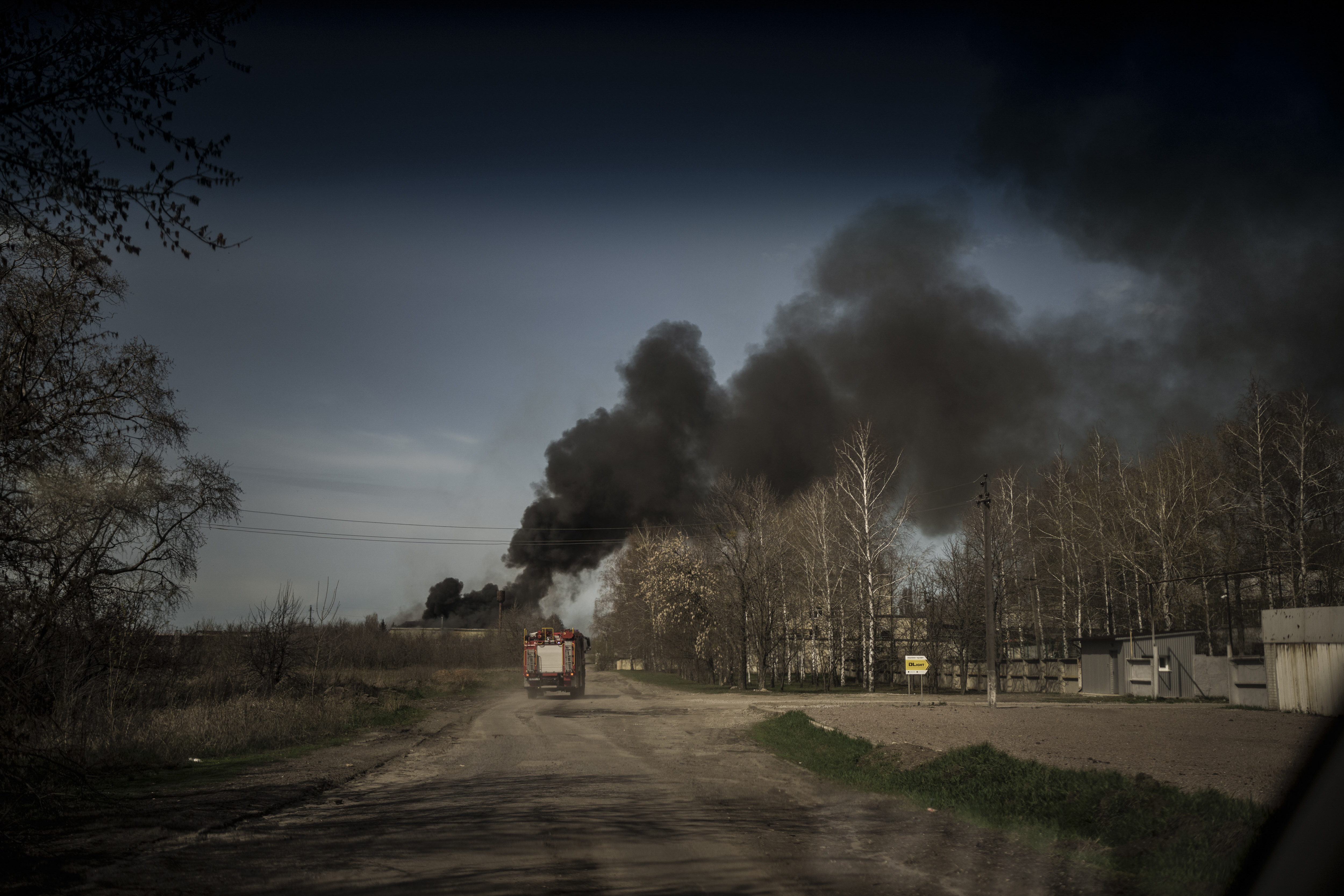 Firefighters drive towards a fire at a factory after a Russian attack, on the outskirts of Kharkiv, Ukraine, on April 15. 