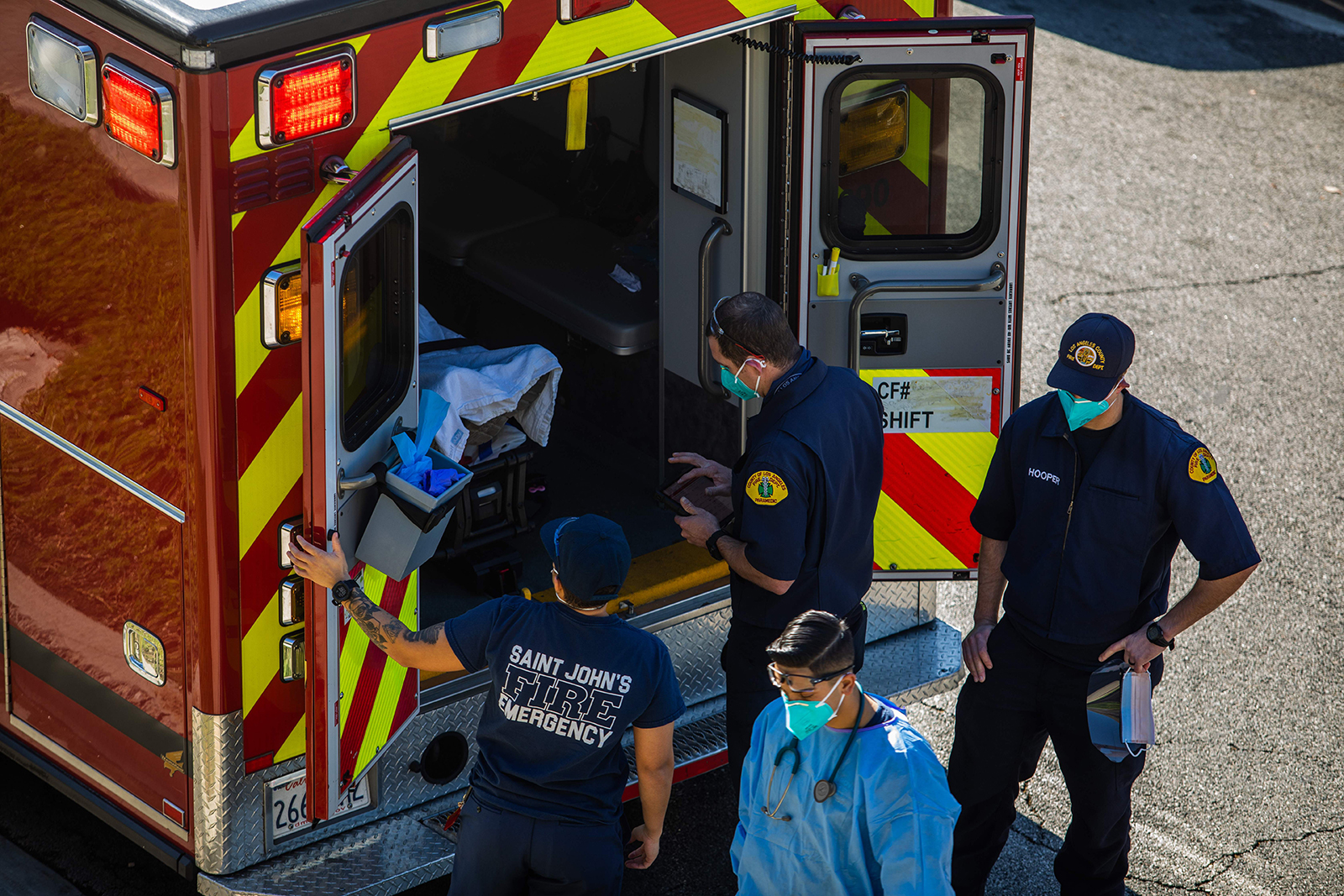After administering him with oxygen, County of Los Angeles paramedics load a potential Covid-19 patient in the ambulance before transporting him to a hospital in Hawthorne, California on December 29, 2020.