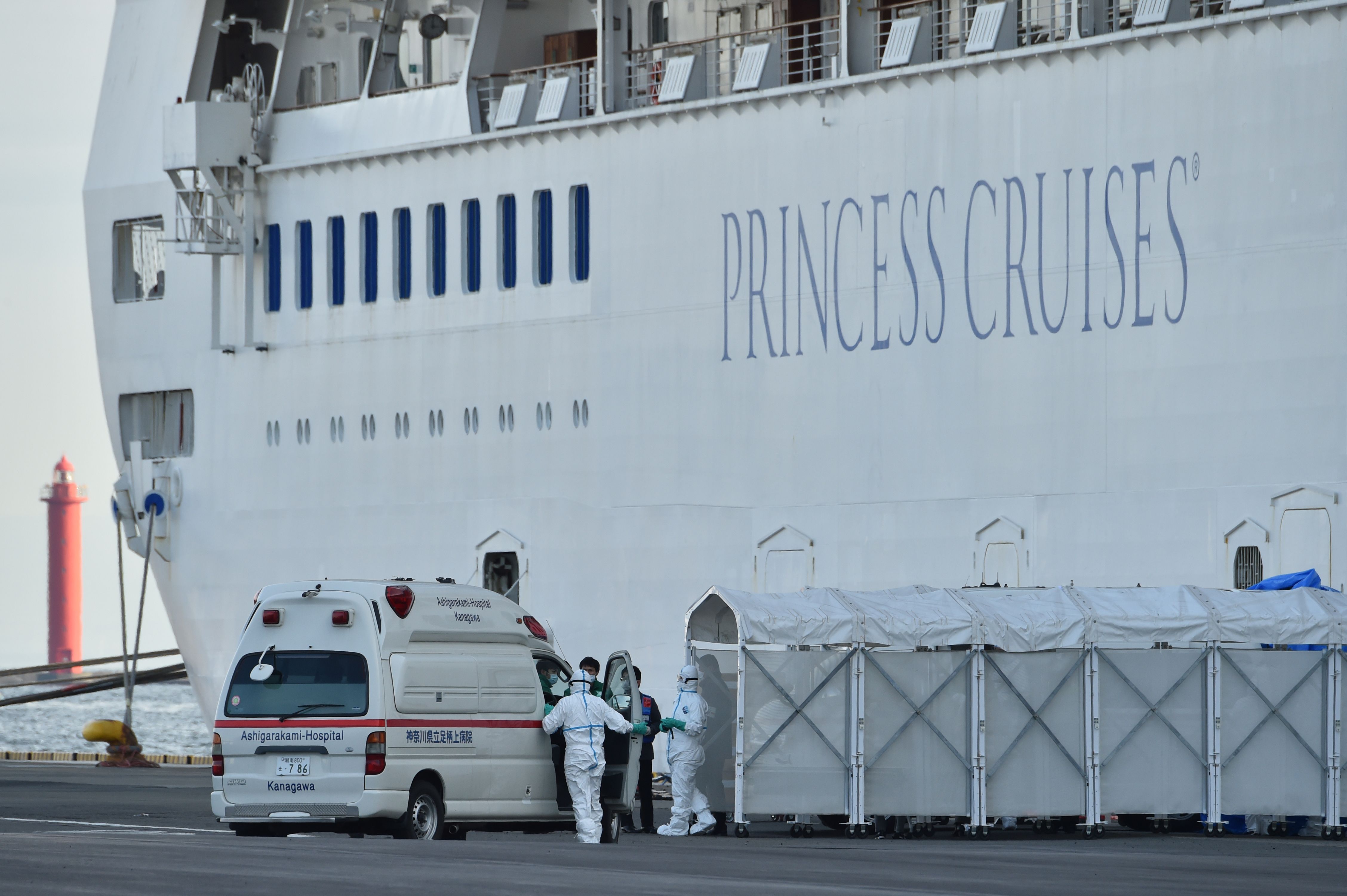 Personnel next to the Diamond Princess cruise ship in Yokohama, Japan, on February 7.