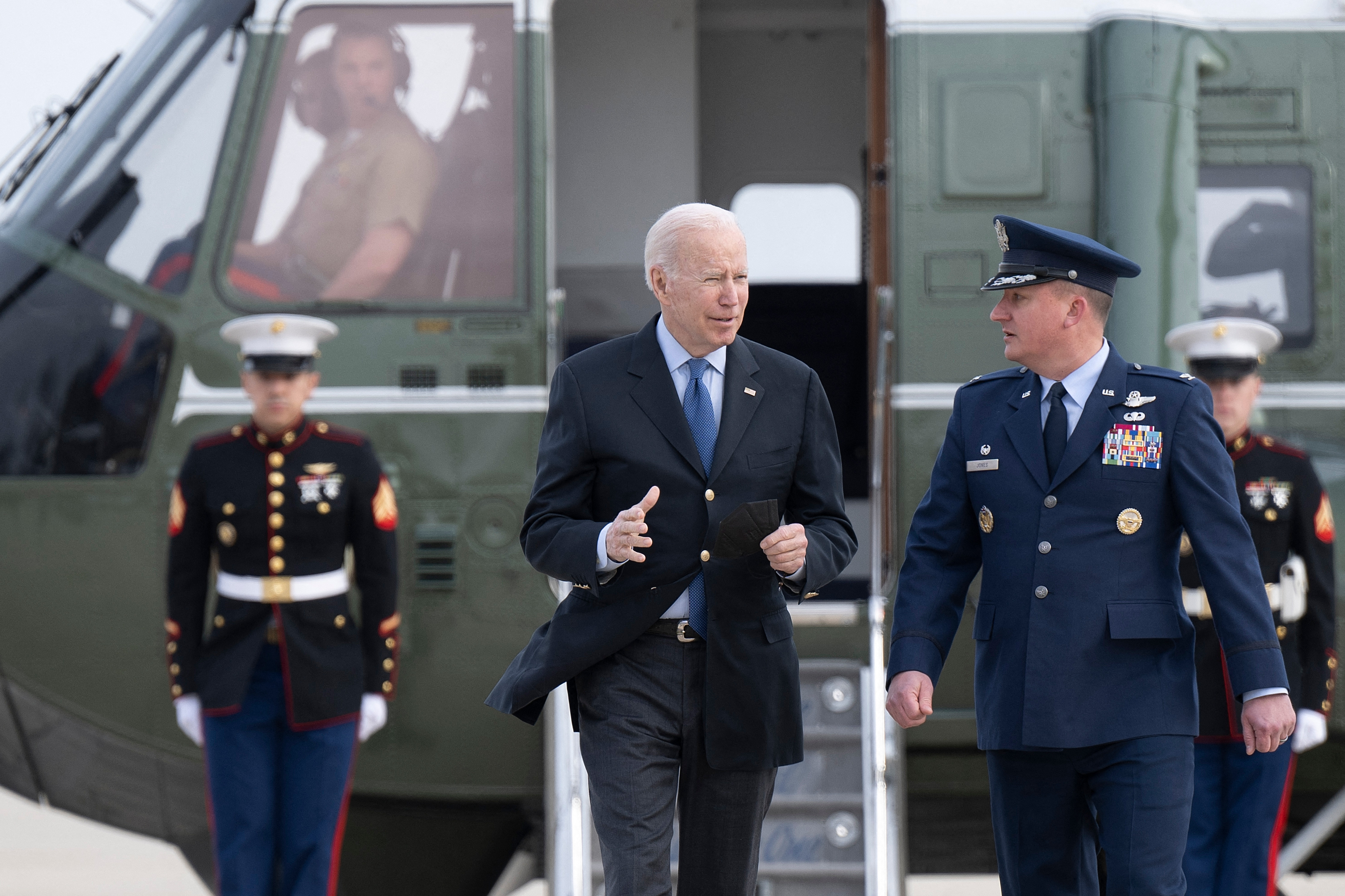 US President Joe Biden is greeted by Colonel Matthew Jones, Commander, 89th Airlift Wing, at Joint Base Andrews in Maryland, on March 23, before beginning a trip to Europe.