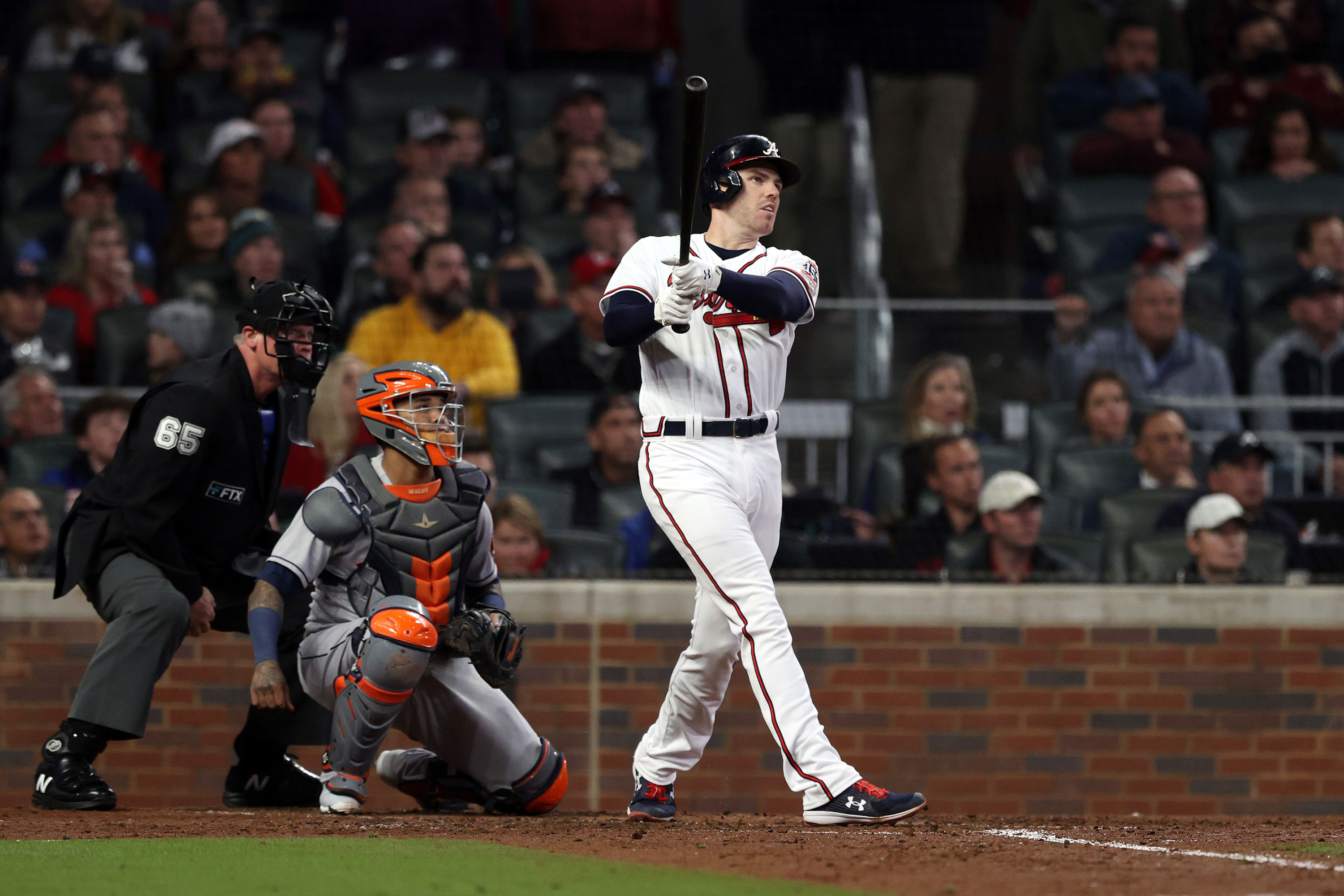 Freddie Freeman of the Braves hits a solo home run during the third inning.