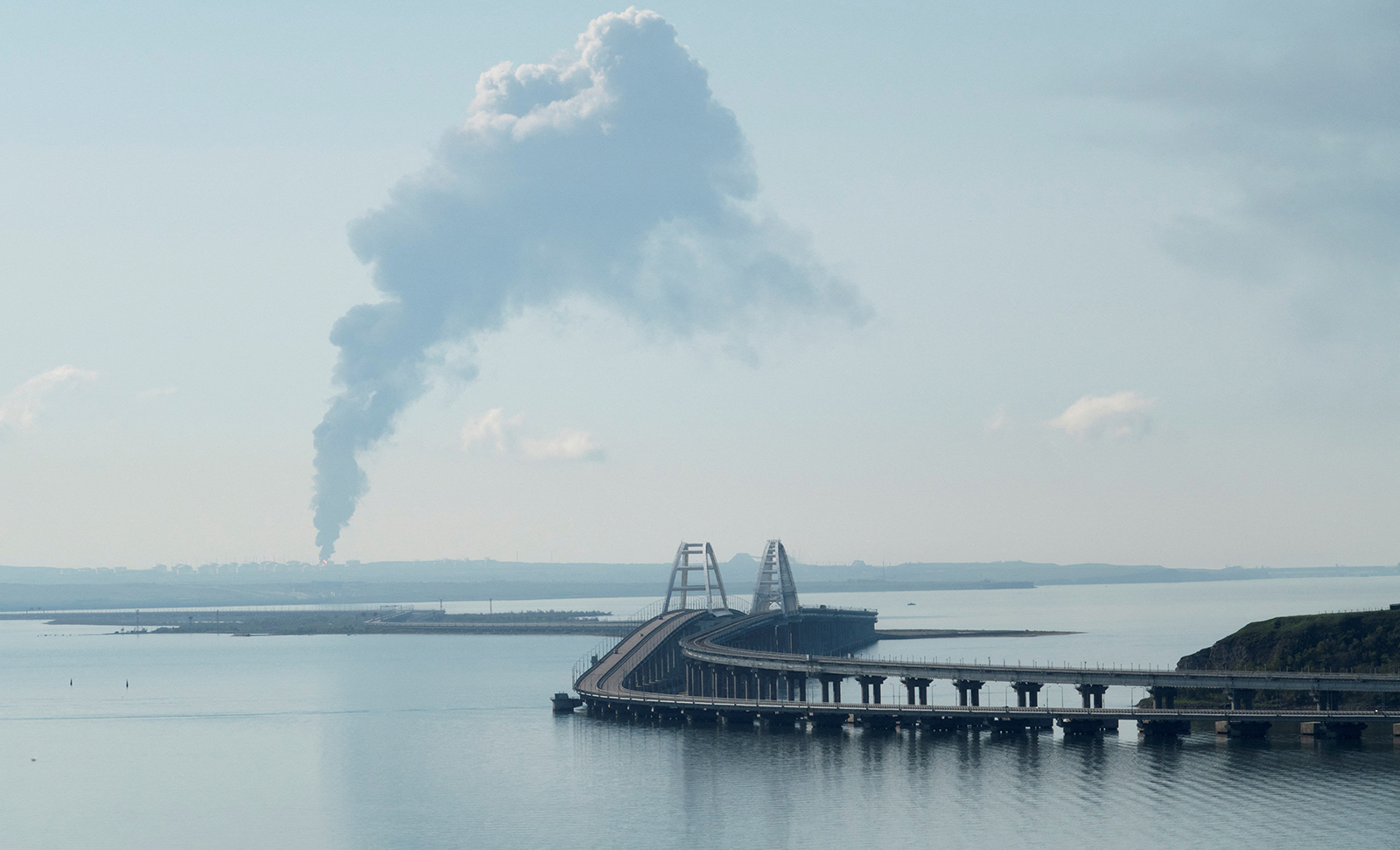 A view across the Kerch Strait shows smoke rising above a fuel depot near the Crimea bridge in Russia's Krasnodar region as seen from a coastline in Crimea, on May 3.