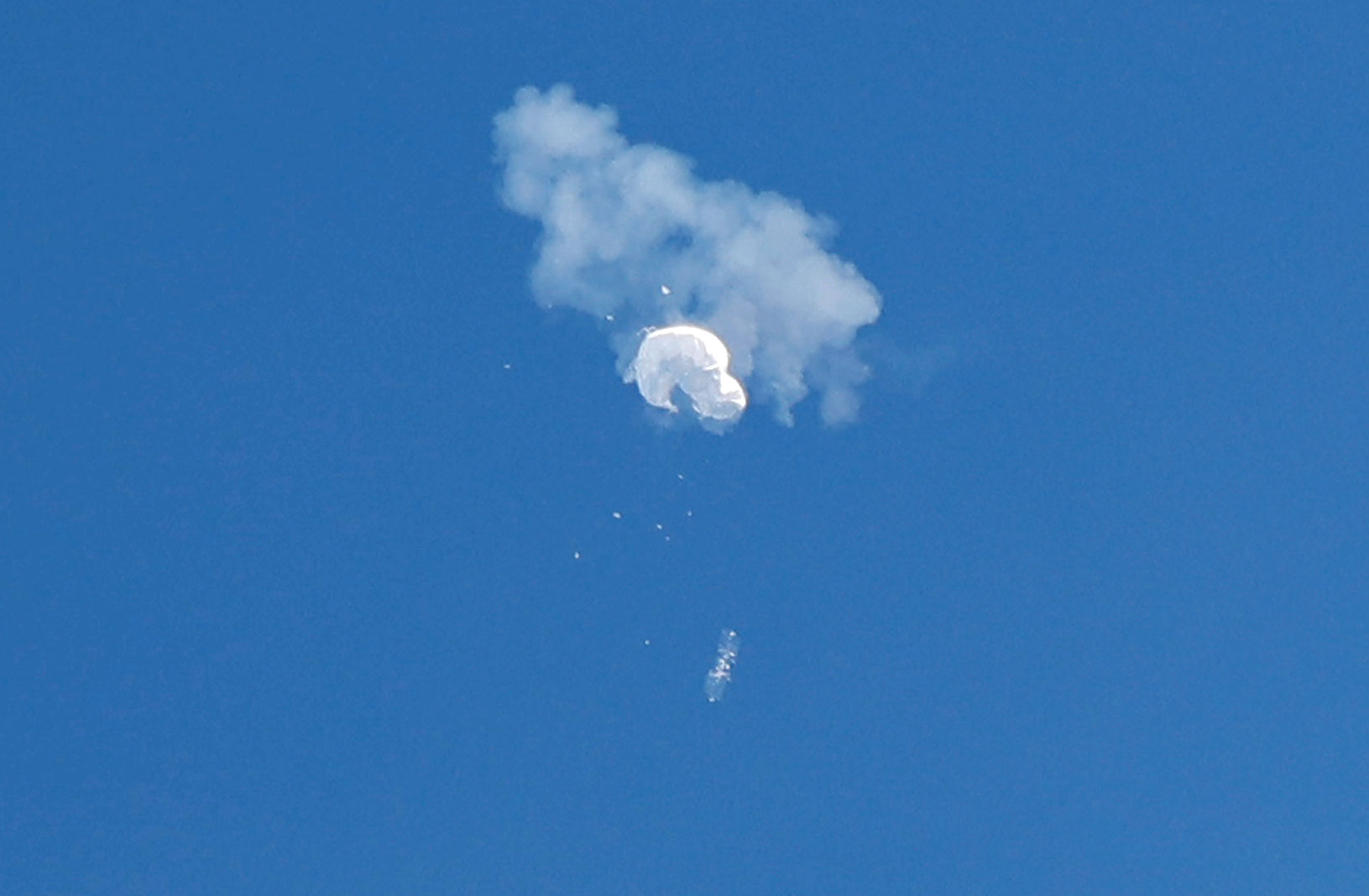 The suspected Chinese spy balloon falls to the ocean after being shot down Saturday, February 4.