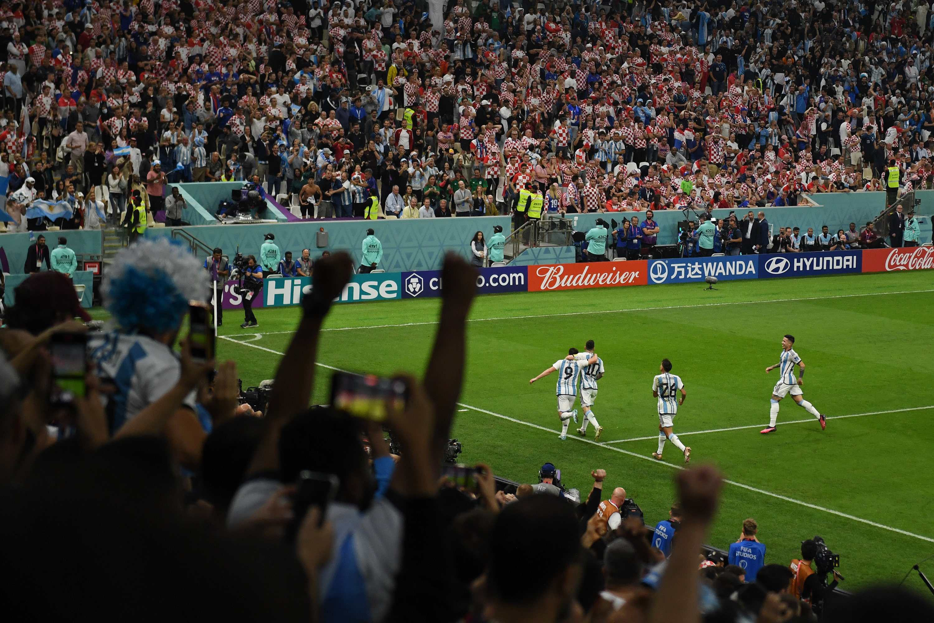 Julián Álvarez and Lionel Messi celebrate after Álvarez scored Argentina's second goal Tuesday.