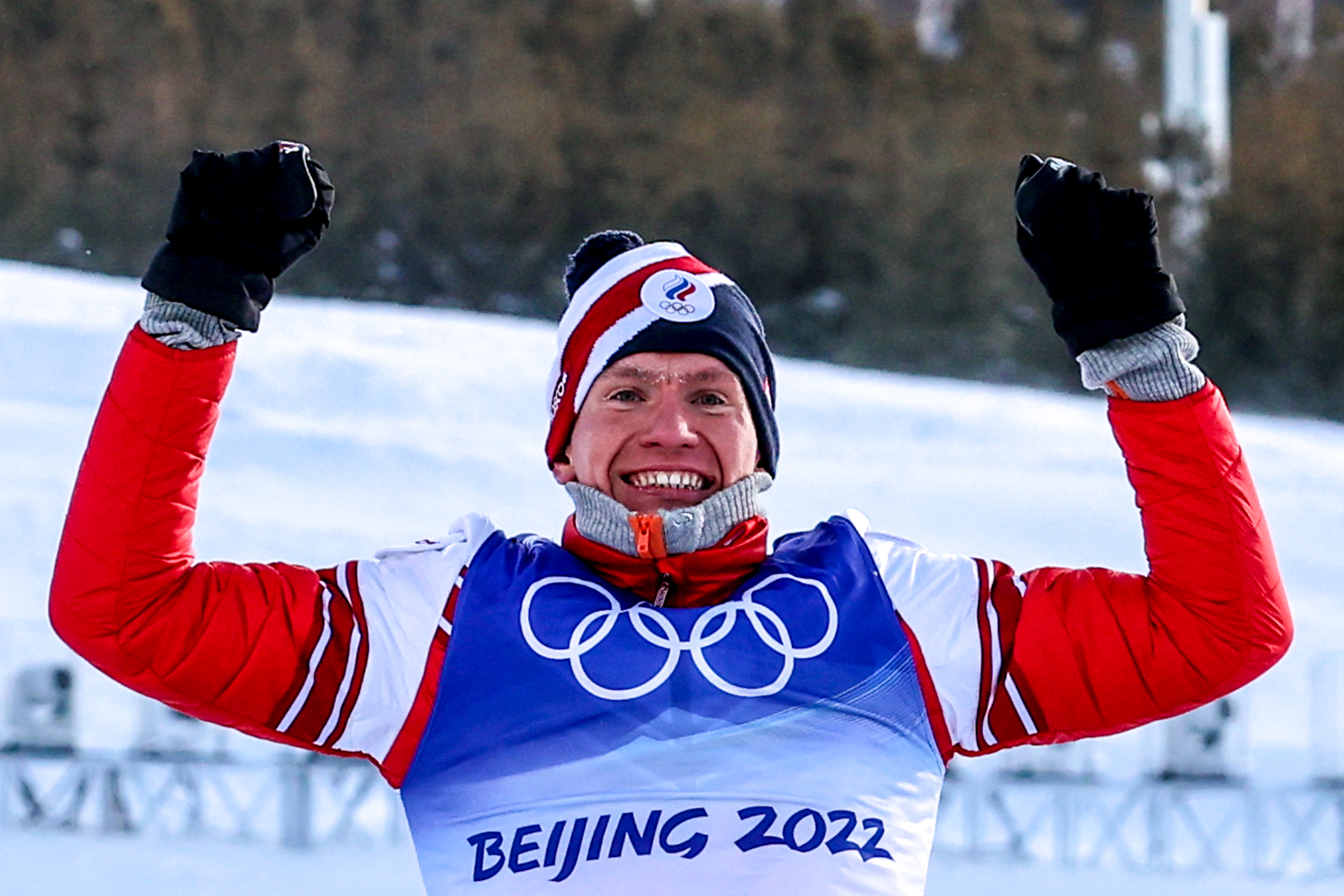 Team ROC's Alexander Bolshunov celebrates during the flower ceremony for men's 30km cross-country skiing mass start race on Saturday.