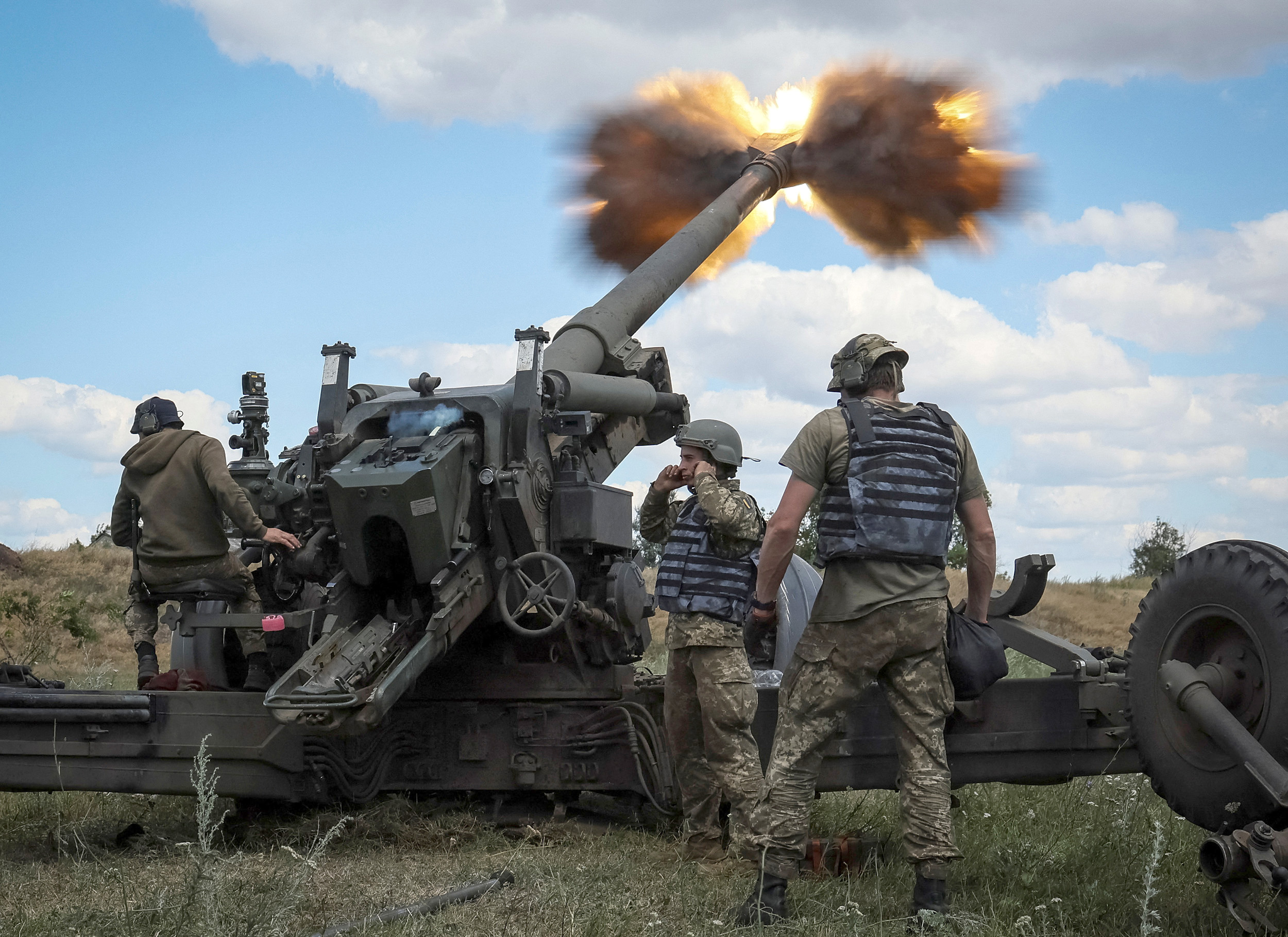 Ukrainian service members fire a shell from a towed howitzer FH-70 at a front line in the Donbas region, Ukraine, on July 18.