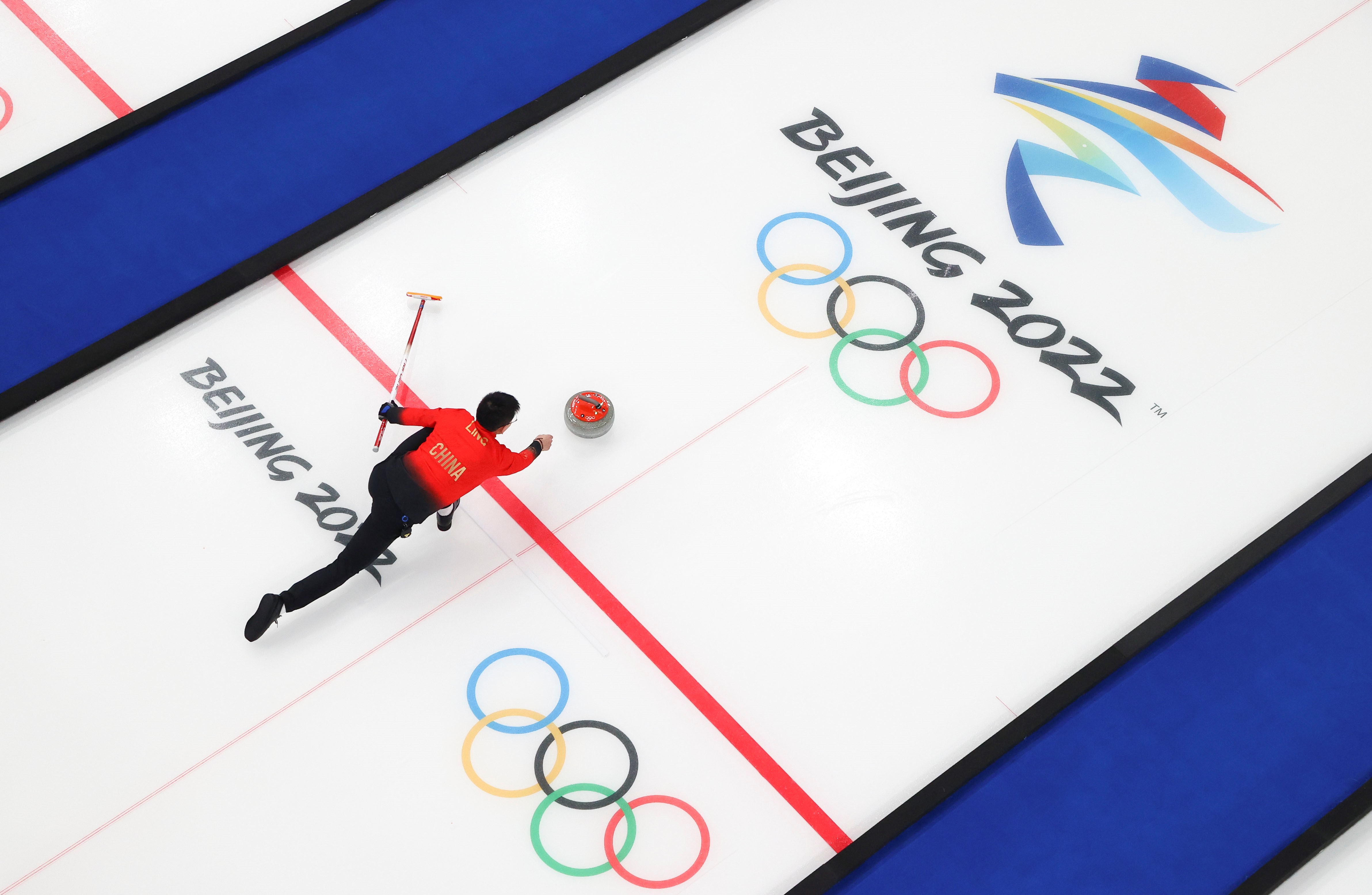 China's Ling Zhi competes during the curling mixed doubles round robin event of the Beijing 2022 Winter Olympics between China and Sweden at National Aquatics Centre.