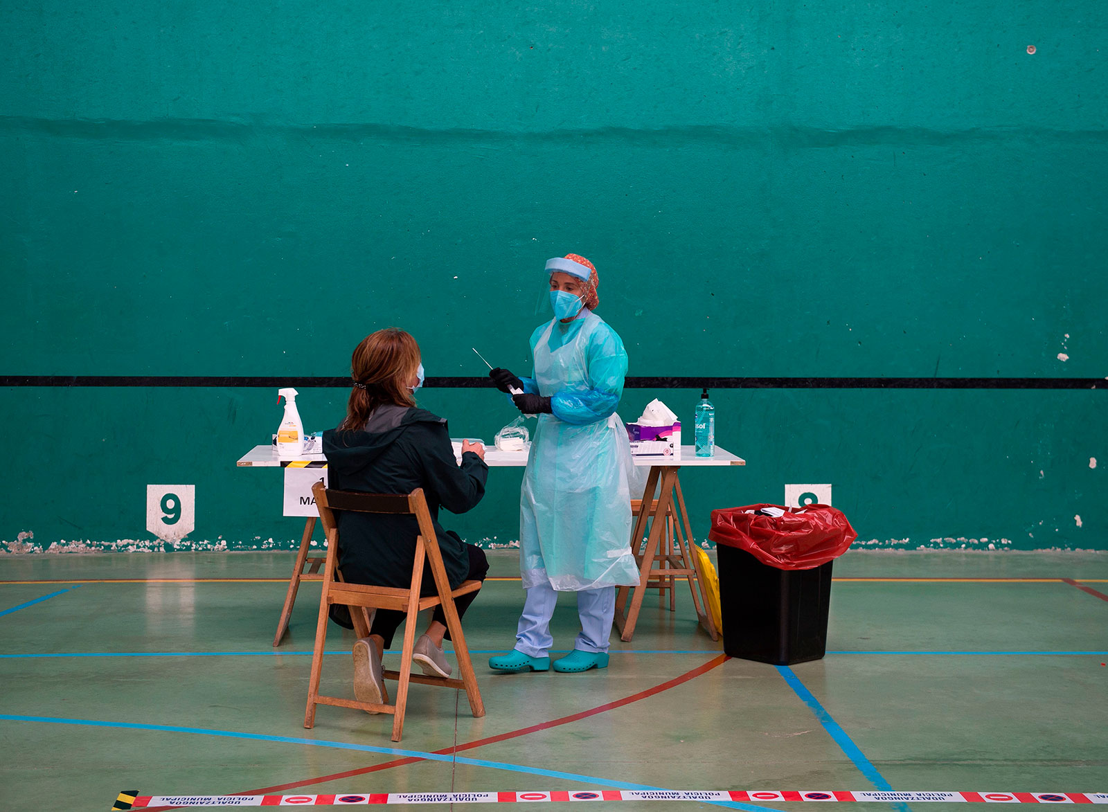A healthcare worker collects a swab sample at a coronavirus testing center in Getaria, Spain, on July 15.