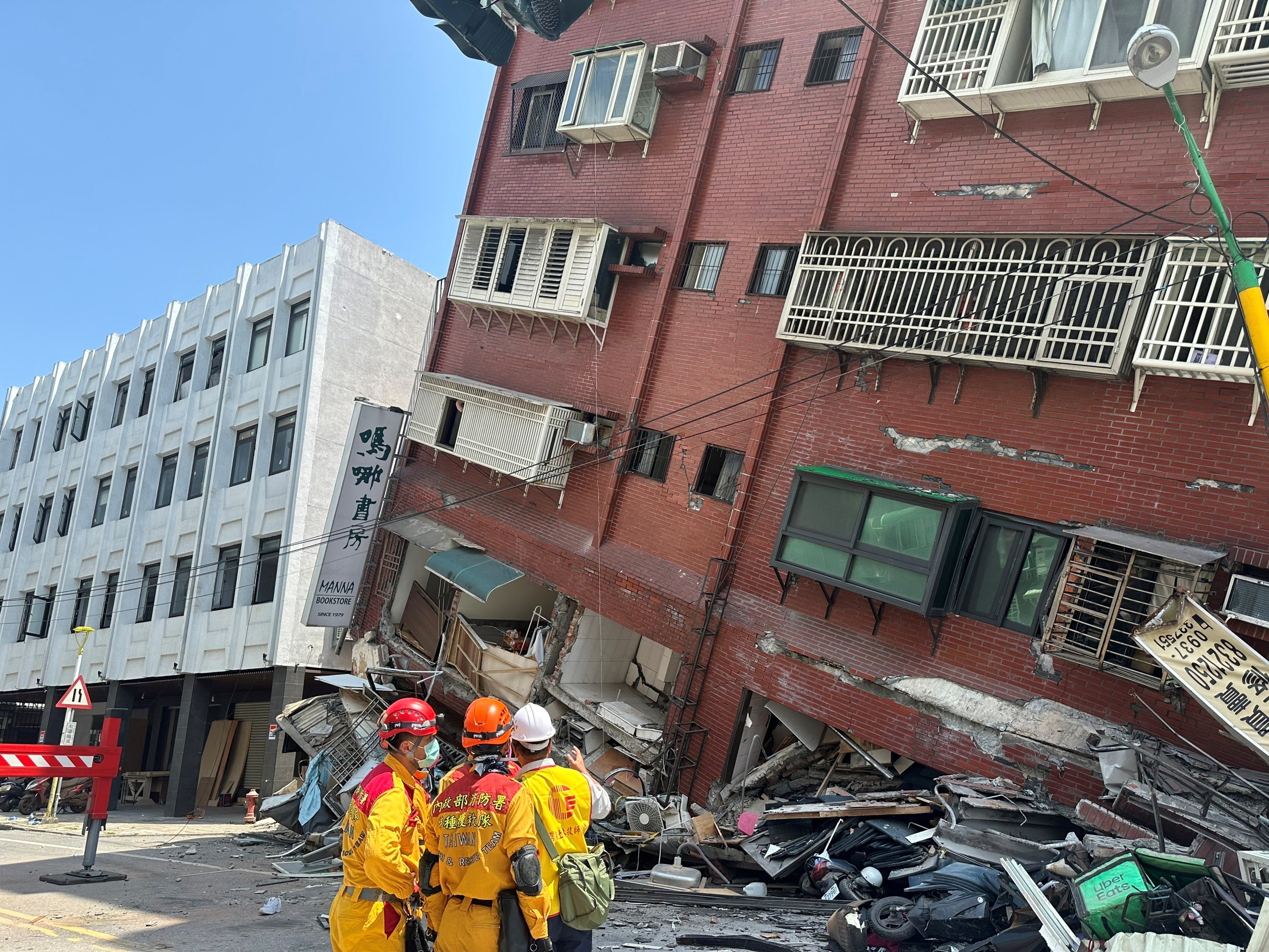 Firefighters work at the site where a building collapsed following the earthquake, in Hualien, Taiwan on April 3.