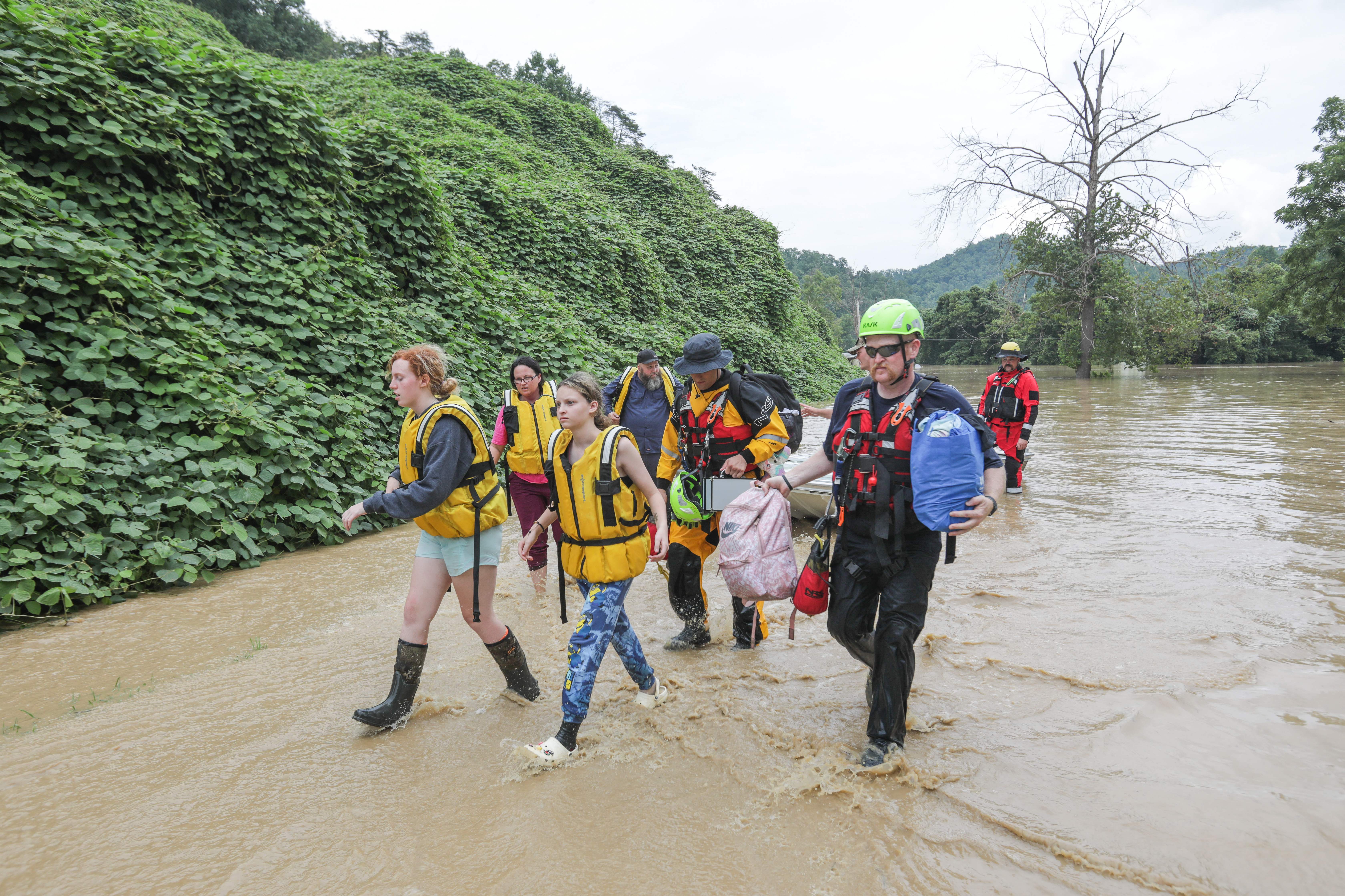 A group of stranded people are rescued from the floodwaters of the North Fork of the Kentucky River in Jackson, Kentucky on July 28.