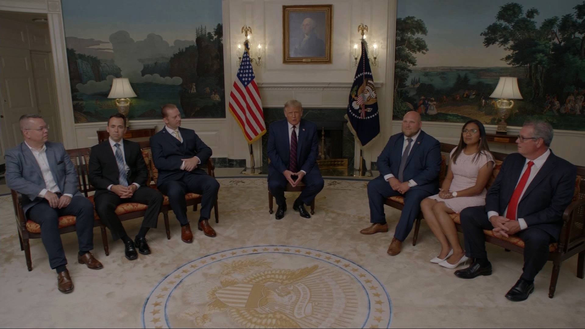 President Trump sits with former hostages and detainees who were freed during his administration.