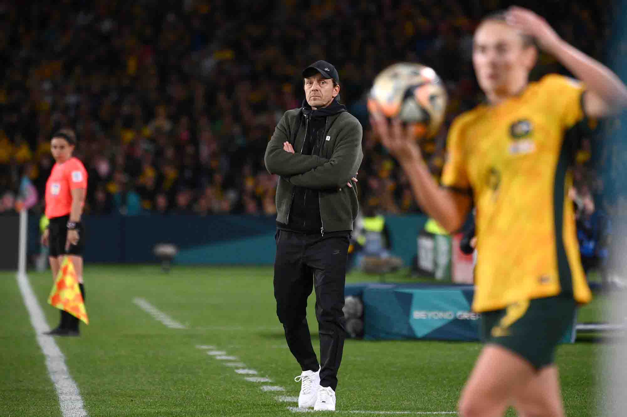 Australia coach Tony Gustavsson watches from the sidelines as his team faces England.
