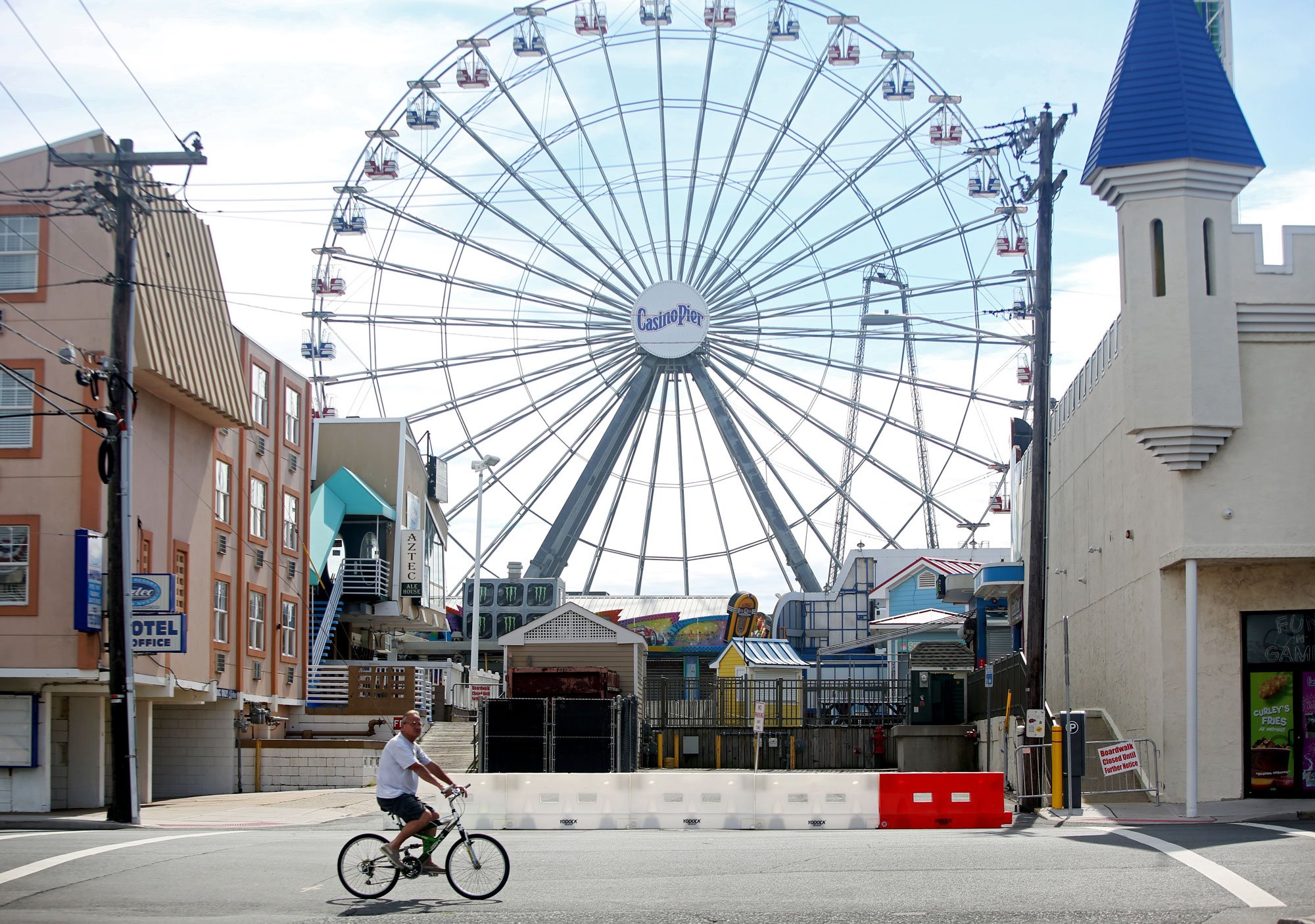 A person on a bike rides past the Seaside Heights boardwalk on May 16 in Seaside Heights, New Jersey. 