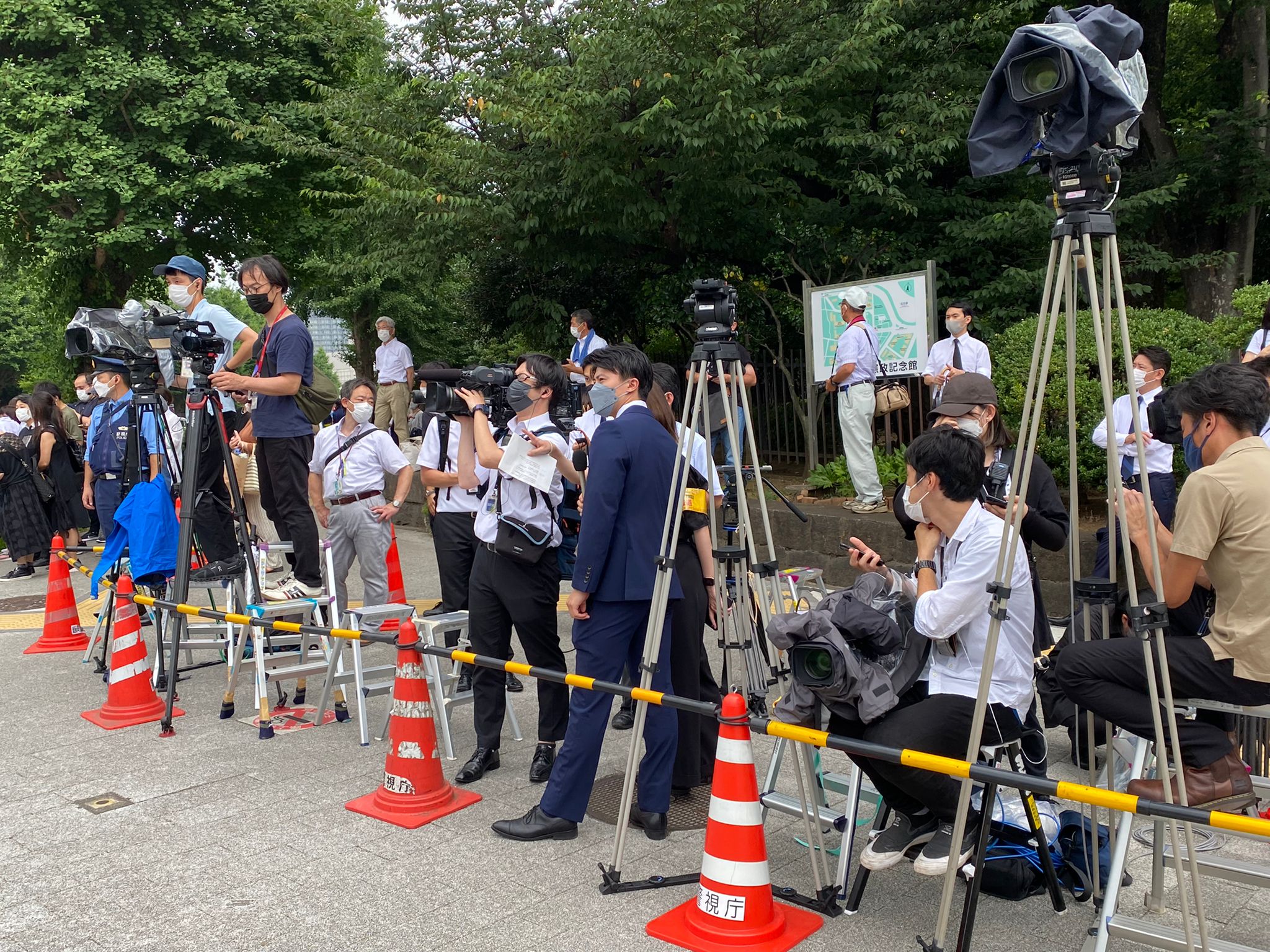 Media stand outside Japan's parliament building on Tuesday.