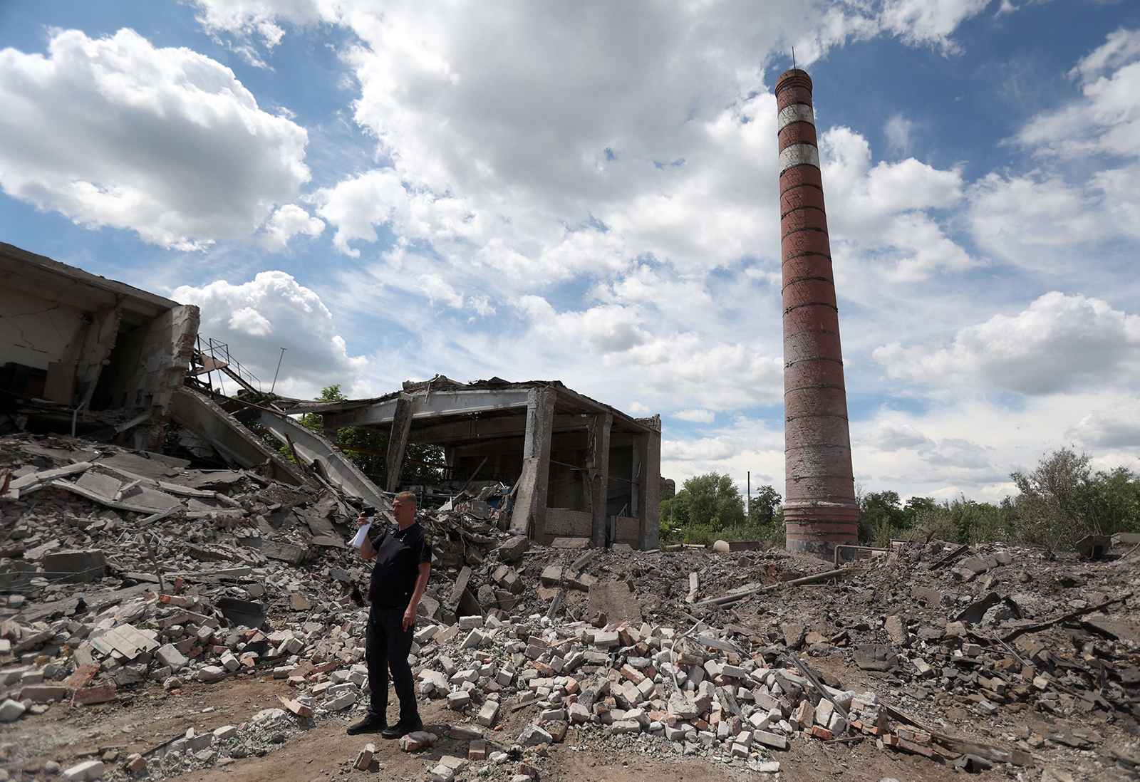 A rescuer stands amid rubbles following the destruction of a heating system plant after a Russian missile attack in Kostyantynivka, in the Donetsk region, on June 24.